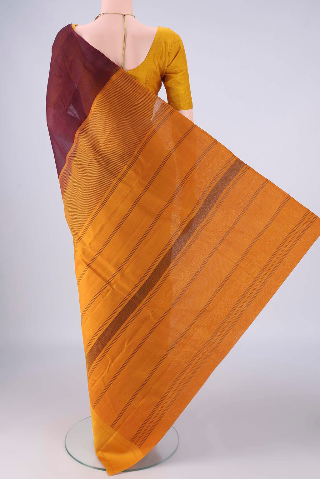 Flat view of Maroon Kanchi Cotton Saree with Plain Body and Temple Border. 