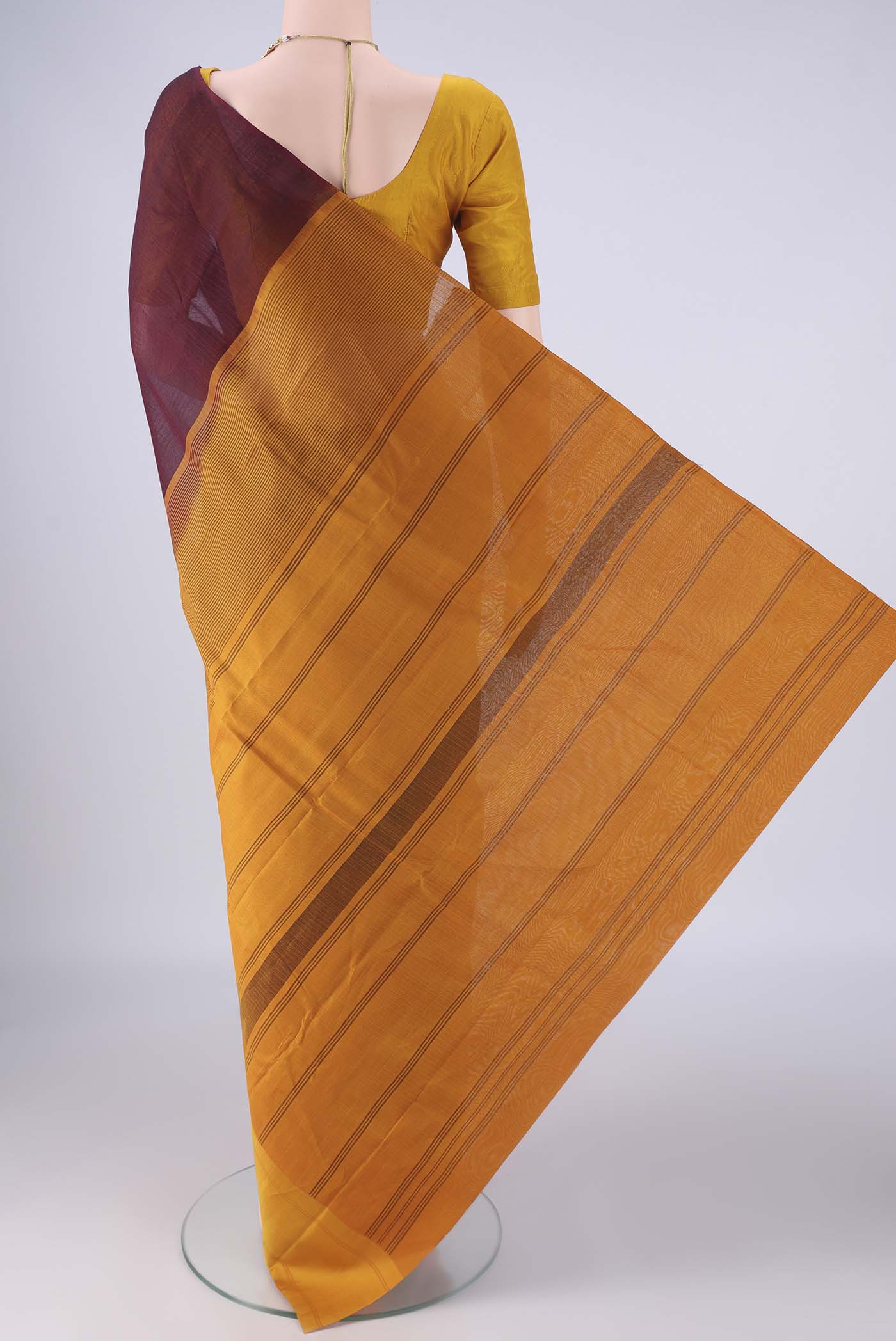 Flat view of Maroon Kanchi Cotton Saree with Plain Body and Temple Border. 