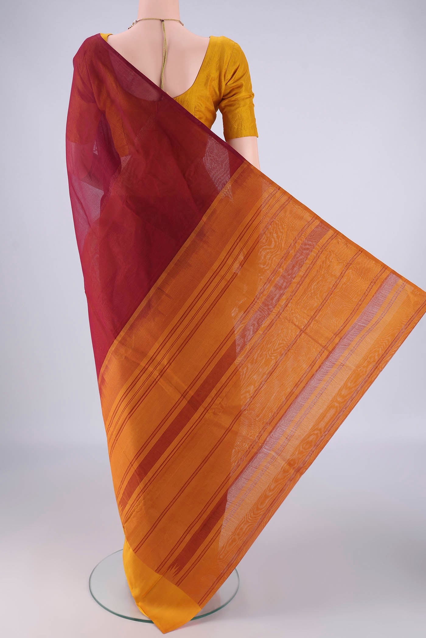 Flat view of Maroon Kanchi Cotton Saree with Plain Body and Temple Thread Border. 