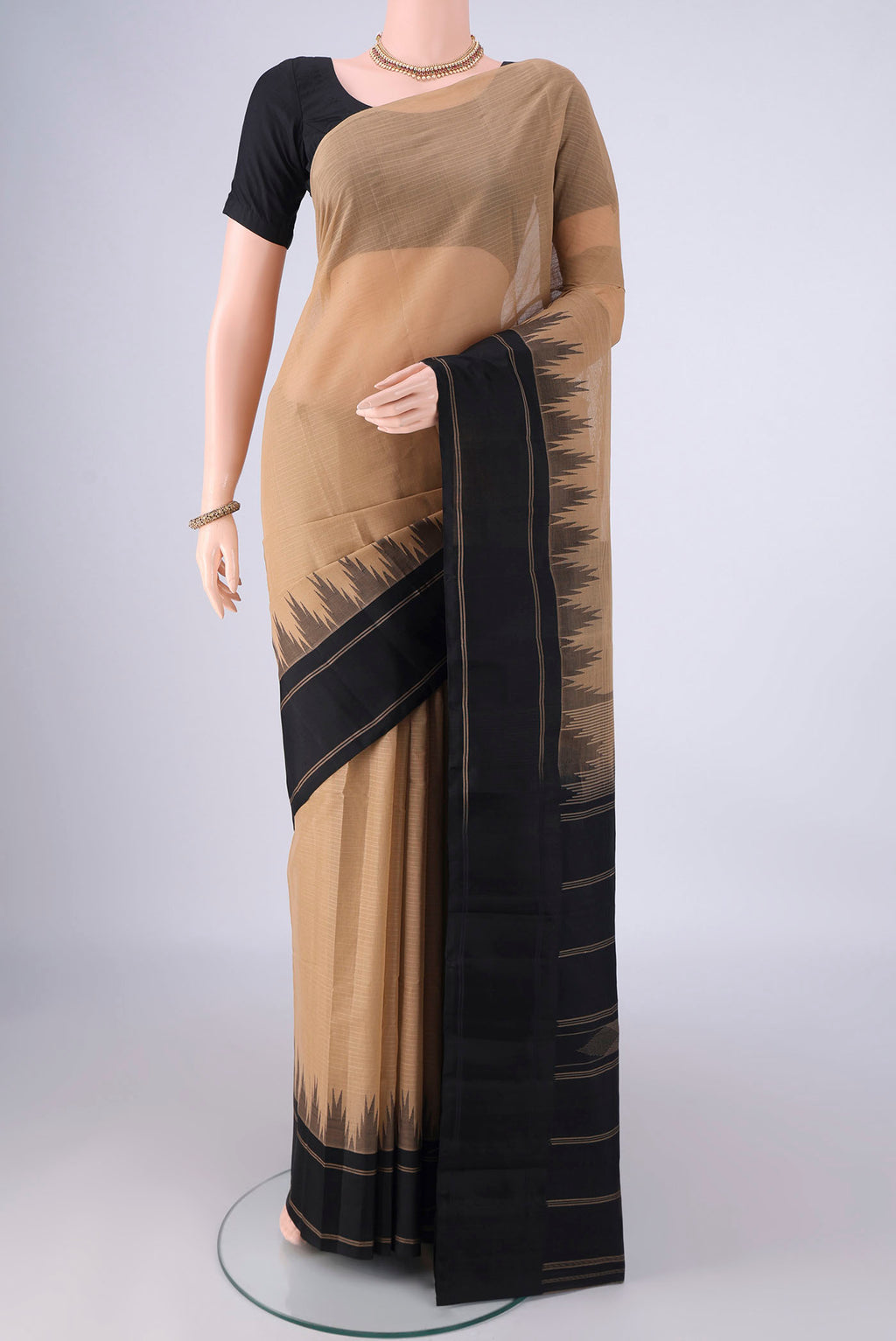Dark Beige Kanchi Cotton Saree with Plain Body and Temple Border.  displayed on a mannequin
