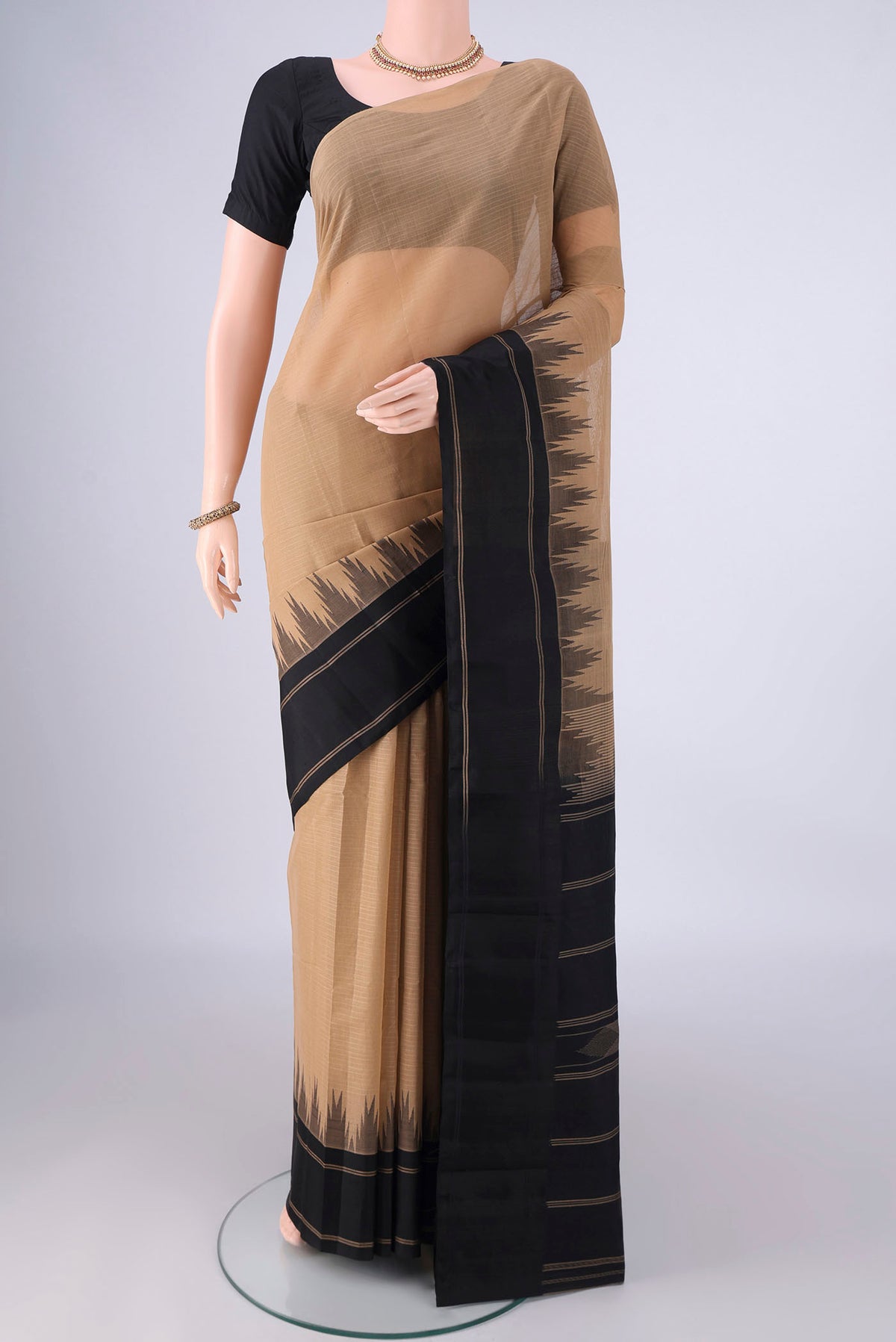 Dark Beige Kanchi Cotton Saree with Plain Body and Temple Border.  displayed on a mannequin