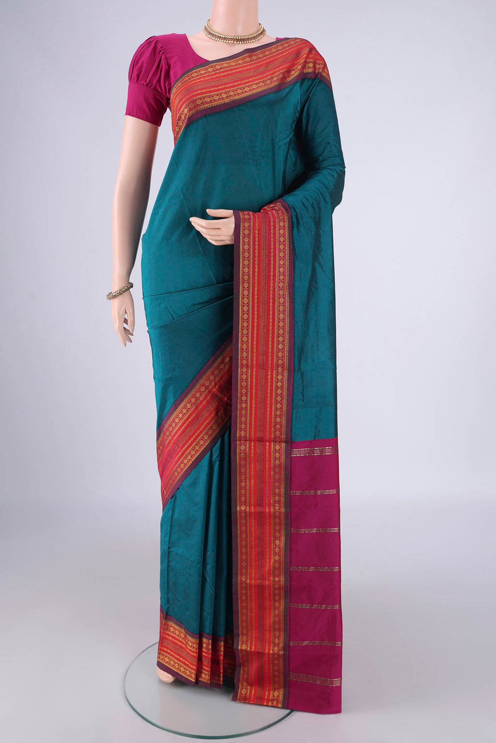 Peacock Blue Blended Bangalore Silk Saree with Plain Body and Zari Border.  displayed on a mannequin