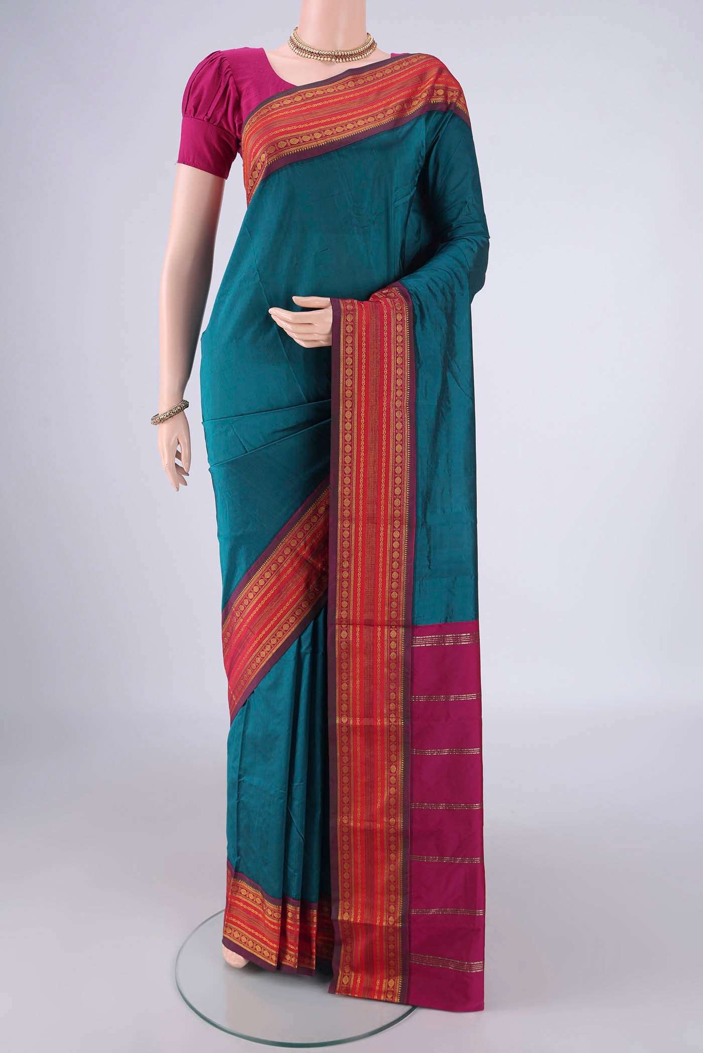 Peacock Blue Blended Bangalore Silk Saree with Plain Body and Zari Border.  displayed on a mannequin