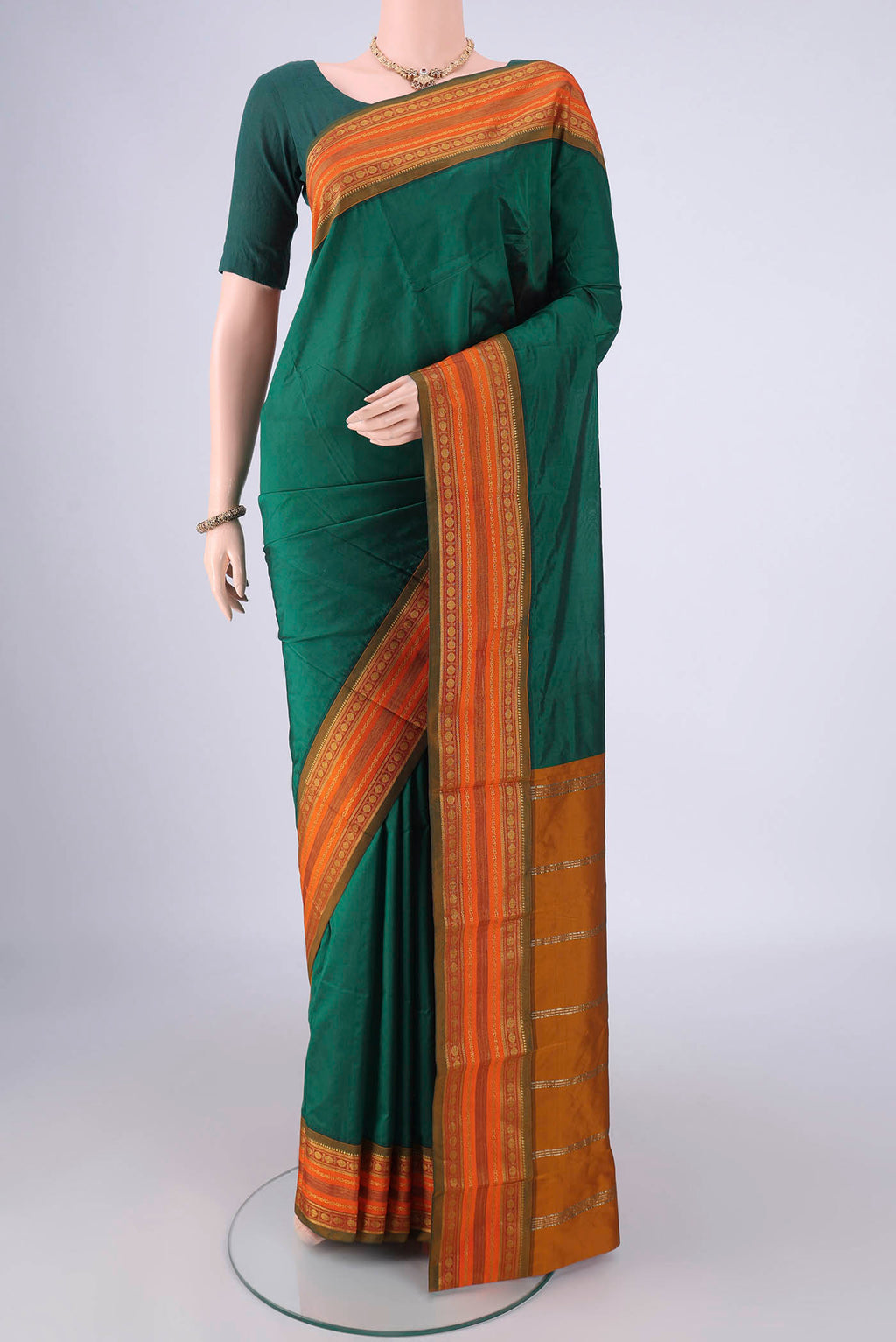 Bottle Green Blended Bangalore Silk Saree with Plain Body and Zari Border.  displayed on a mannequin