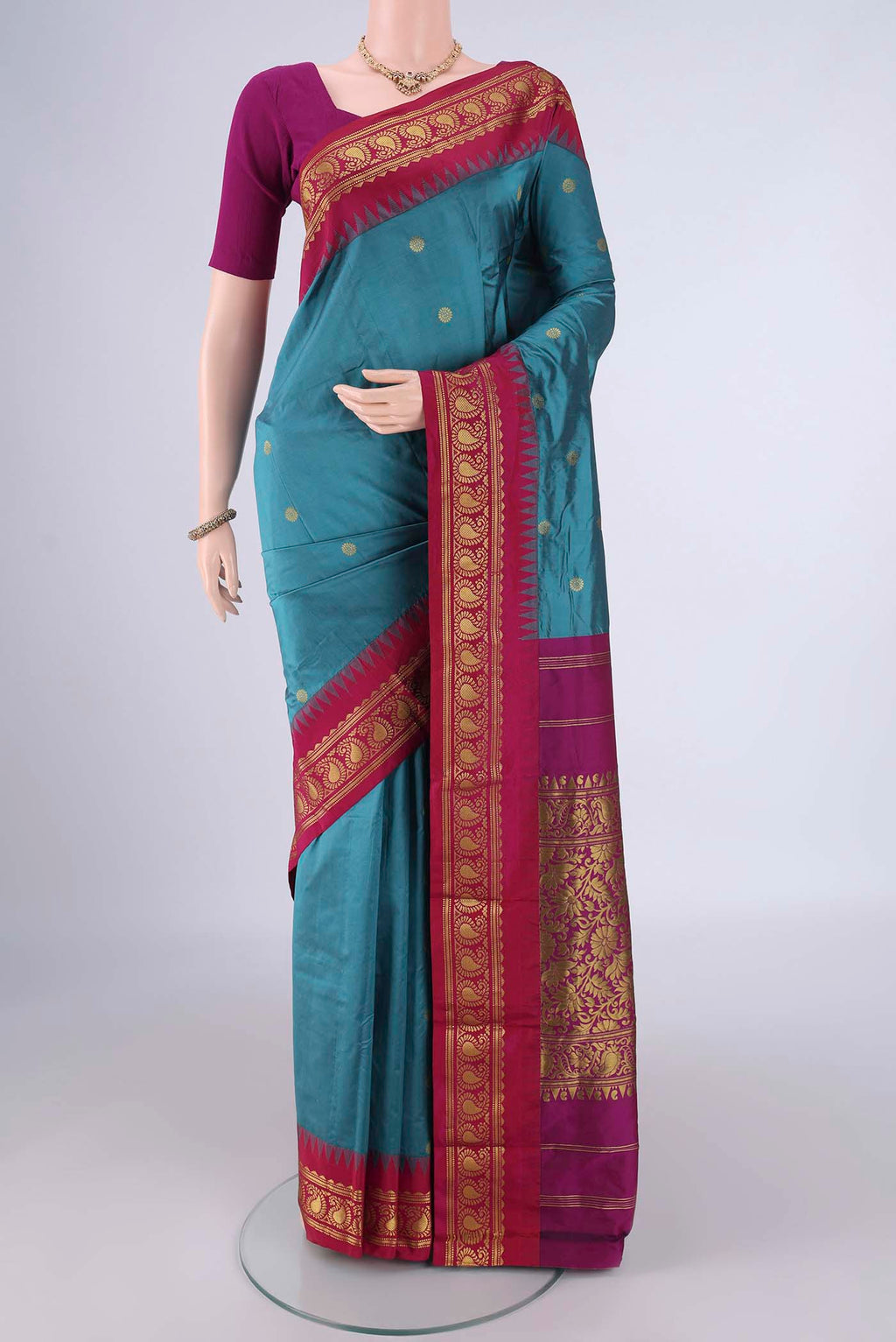 Maya Blue Blended Bangalore Silk Saree with Zari Butta on the body and Temple Border.  displayed on a mannequin