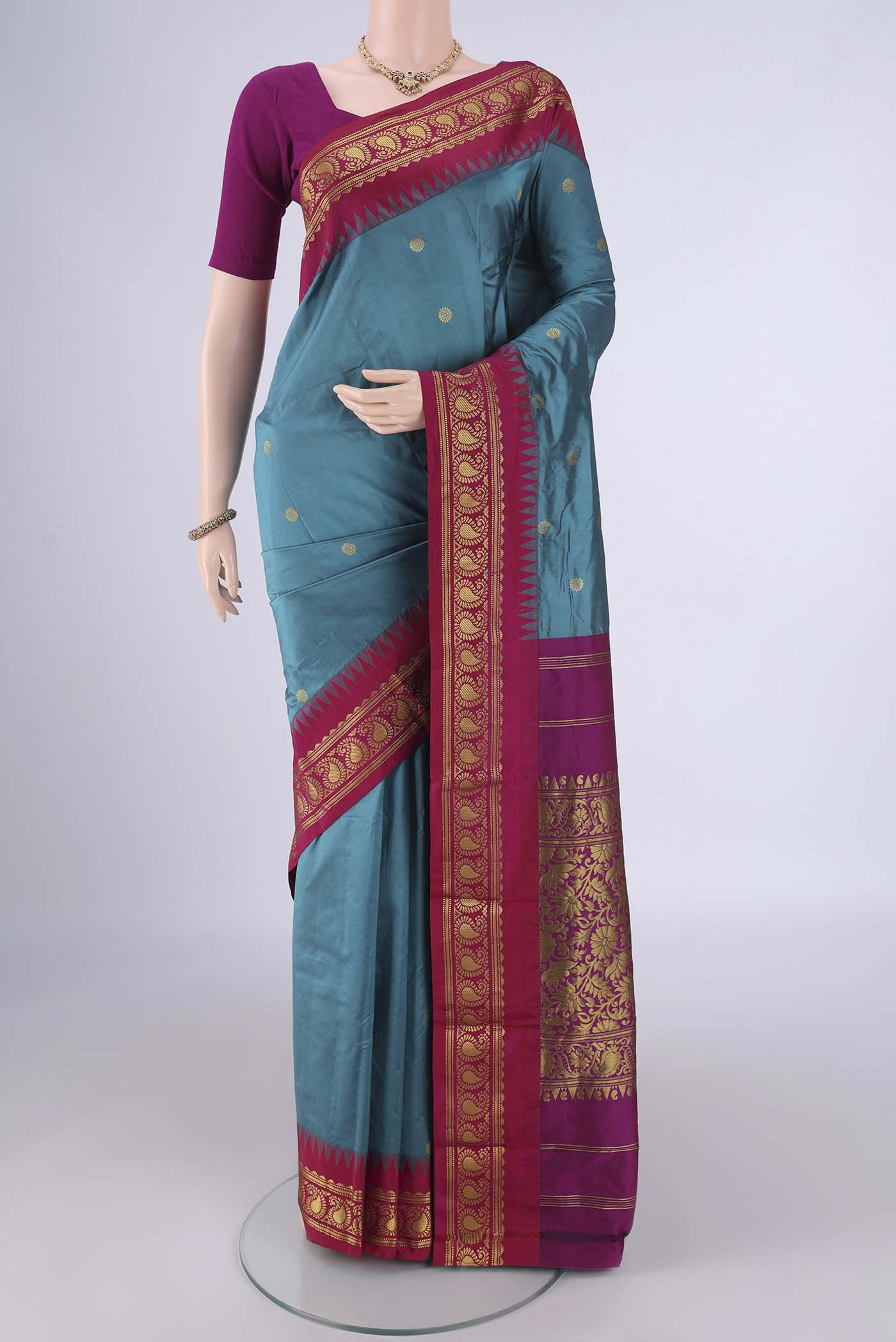 Maya Blue Blended Bangalore Silk Saree with Zari Butta on the body and Temple Border.  displayed on a mannequin
