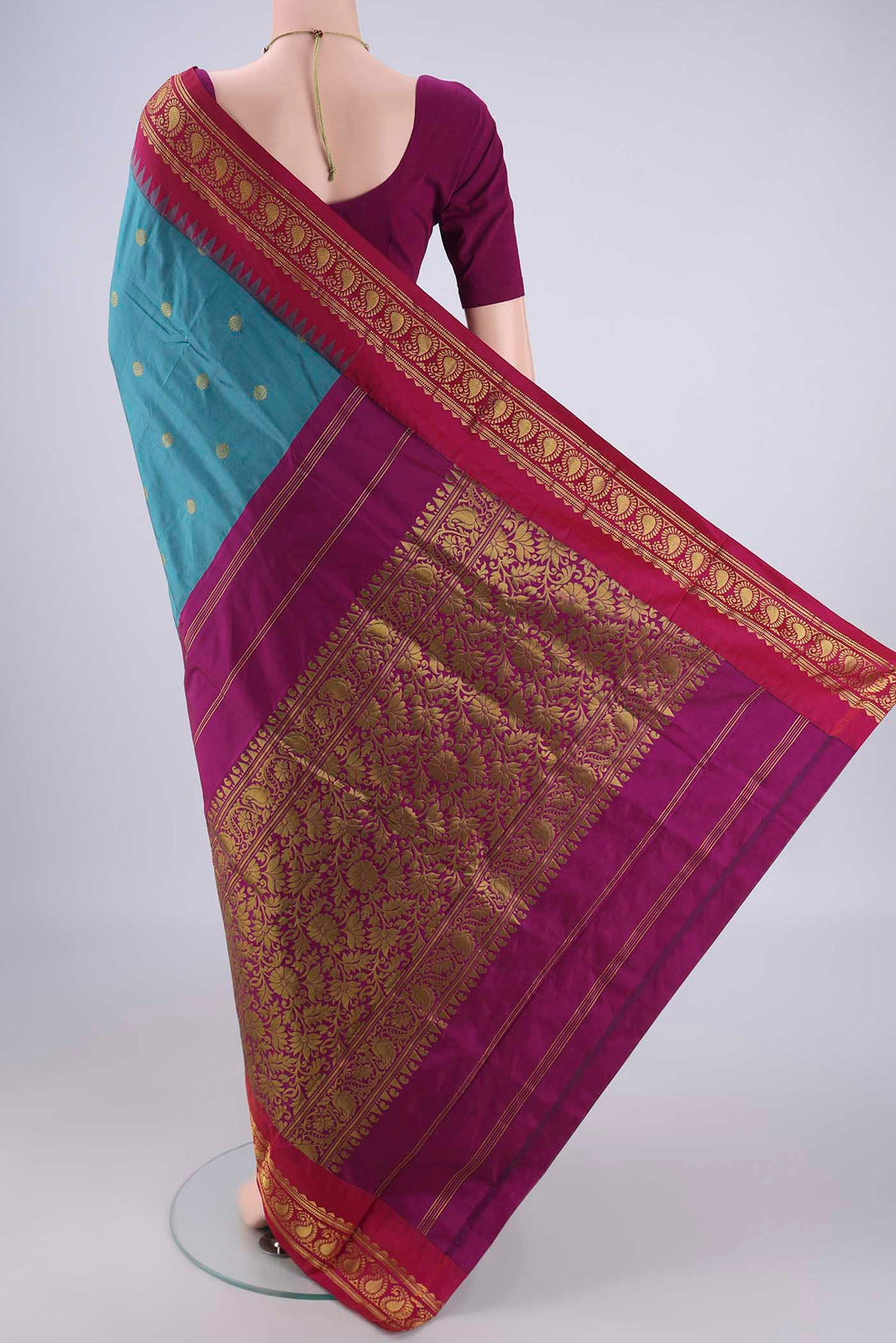 Flat view of Maya Blue Blended Bangalore Silk Saree with Zari Butta on the body and Temple Border. 