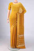 Mustard Mysore Chiffon Saree with Zari Butta on the body and Thin Zari Line.  displayed on a mannequin
