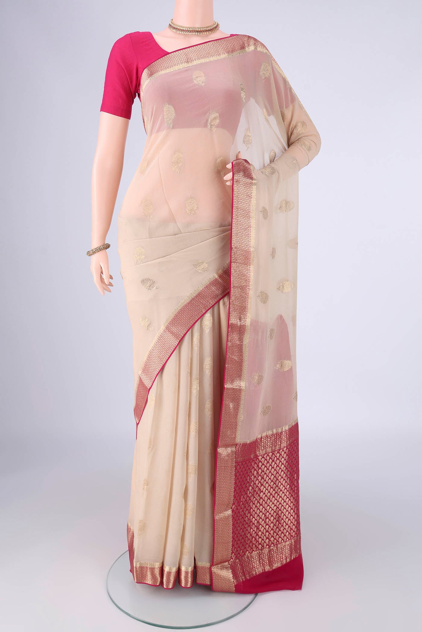 Beige Mysore Georgette Saree with Zari Butta on the body and Zari Border.  displayed on a mannequin