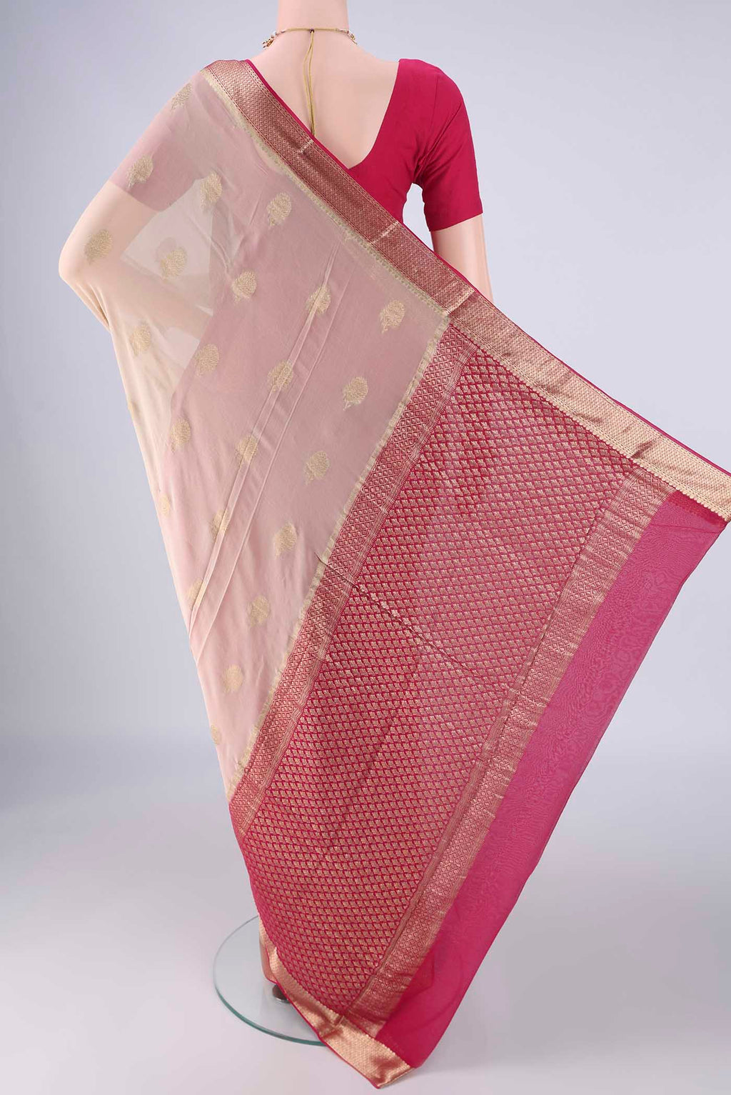 Flat view of Beige Mysore Georgette Saree with Zari Butta on the body and Zari Border. 