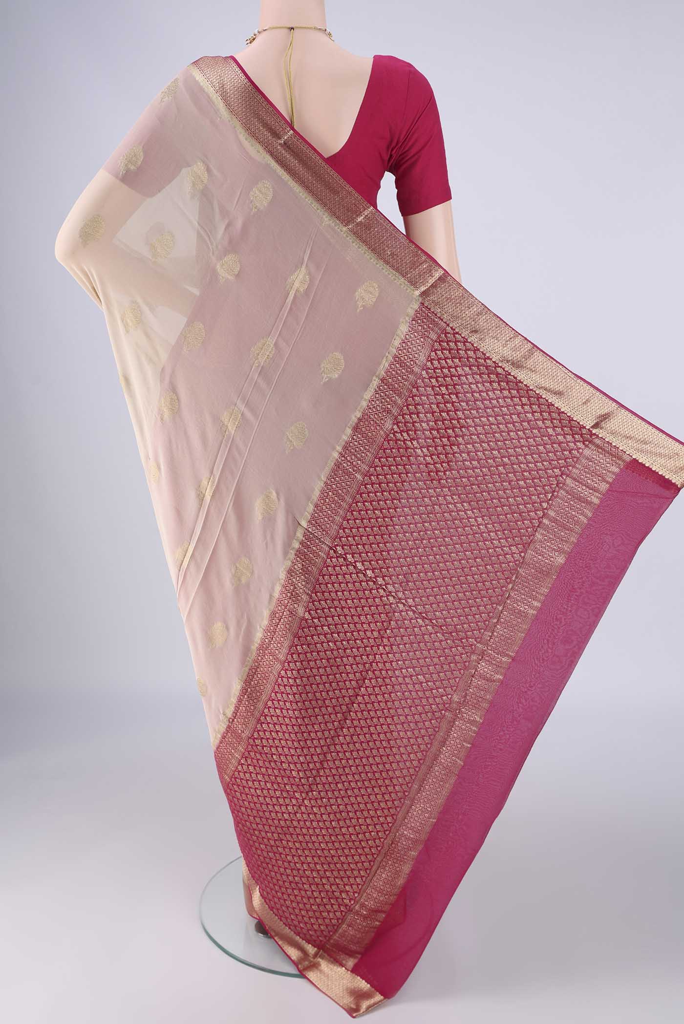 Flat view of Beige Mysore Georgette Saree with Zari Butta on the body and Zari Border. 