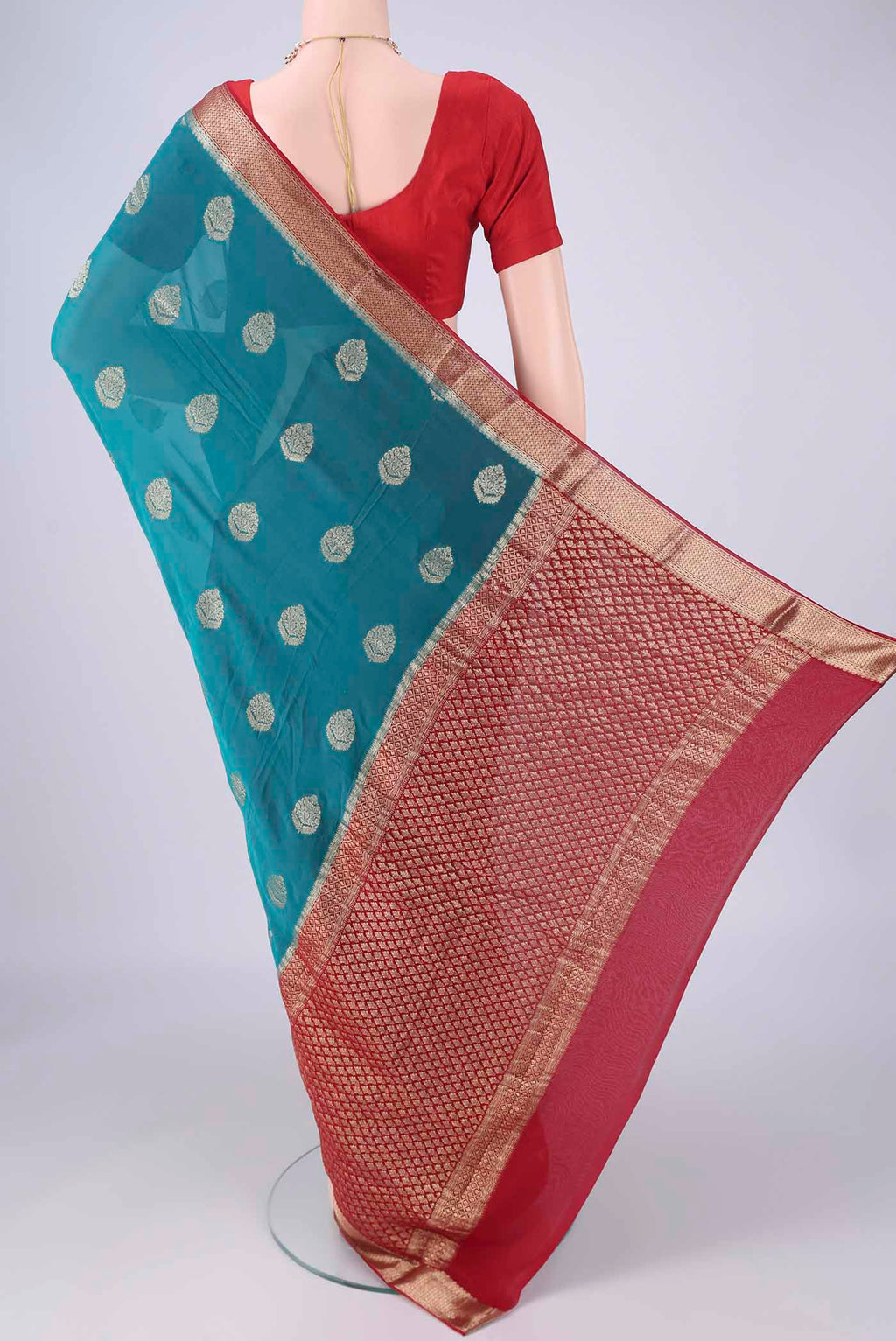Flat view of Blue Mysore Georgette Saree with Zari Butta on the body and Zari Border. 