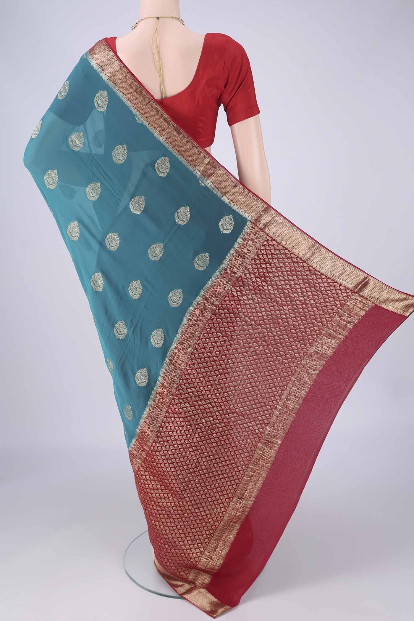 Flat view of Blue Mysore Georgette Saree with Zari Butta on the body and Zari Border. 