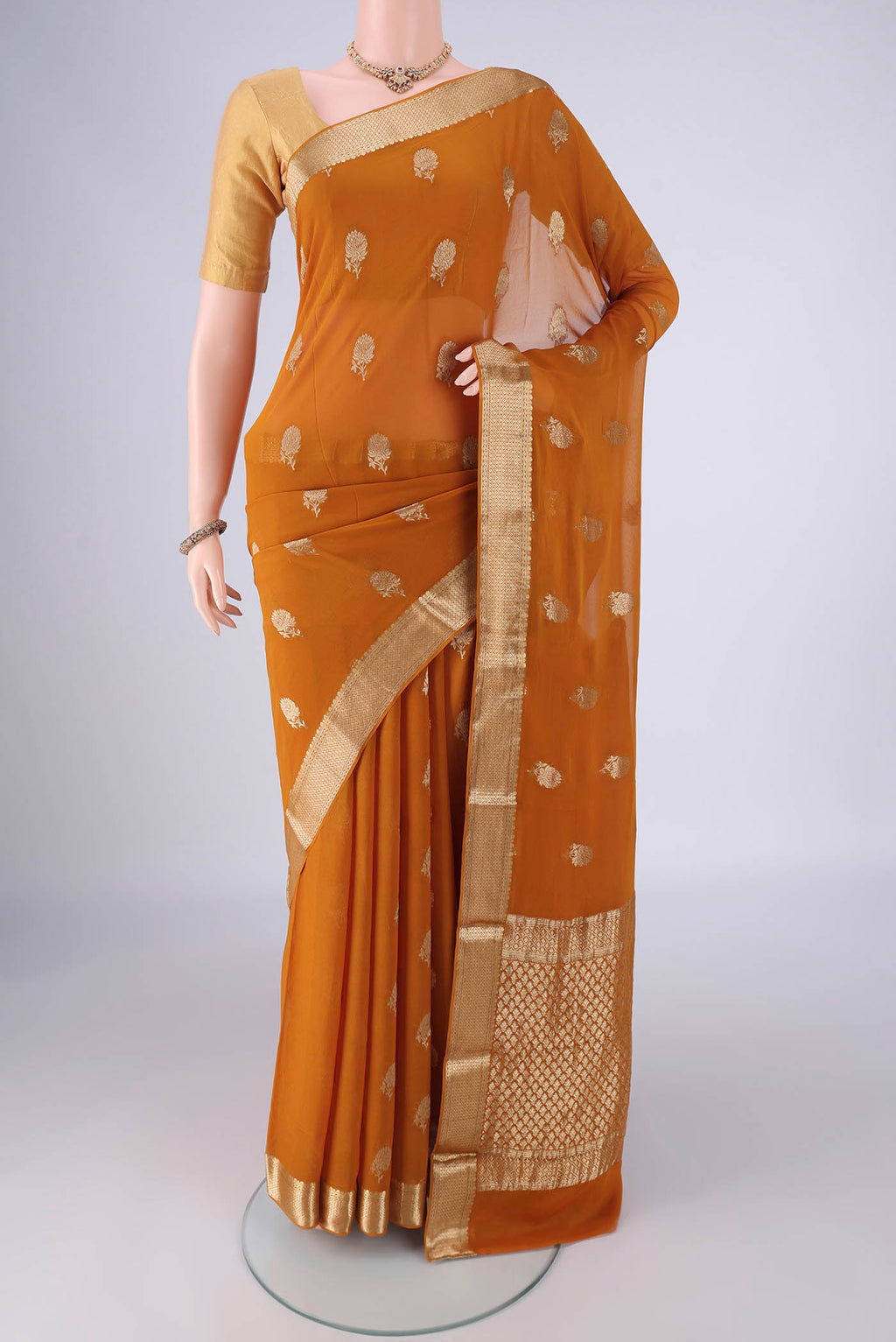 Mustard Mysore Georgette Saree with Zari Butta on the body and Zari Border.  displayed on a mannequin