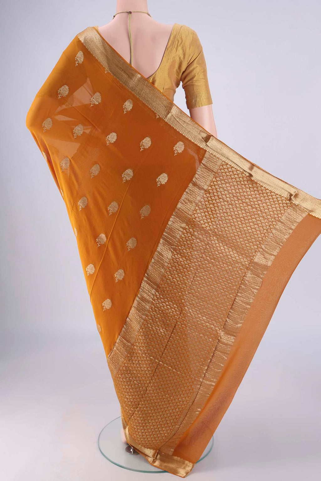 Flat view of Mustard Mysore Georgette Saree with Zari Butta on the body and Zari Border. 