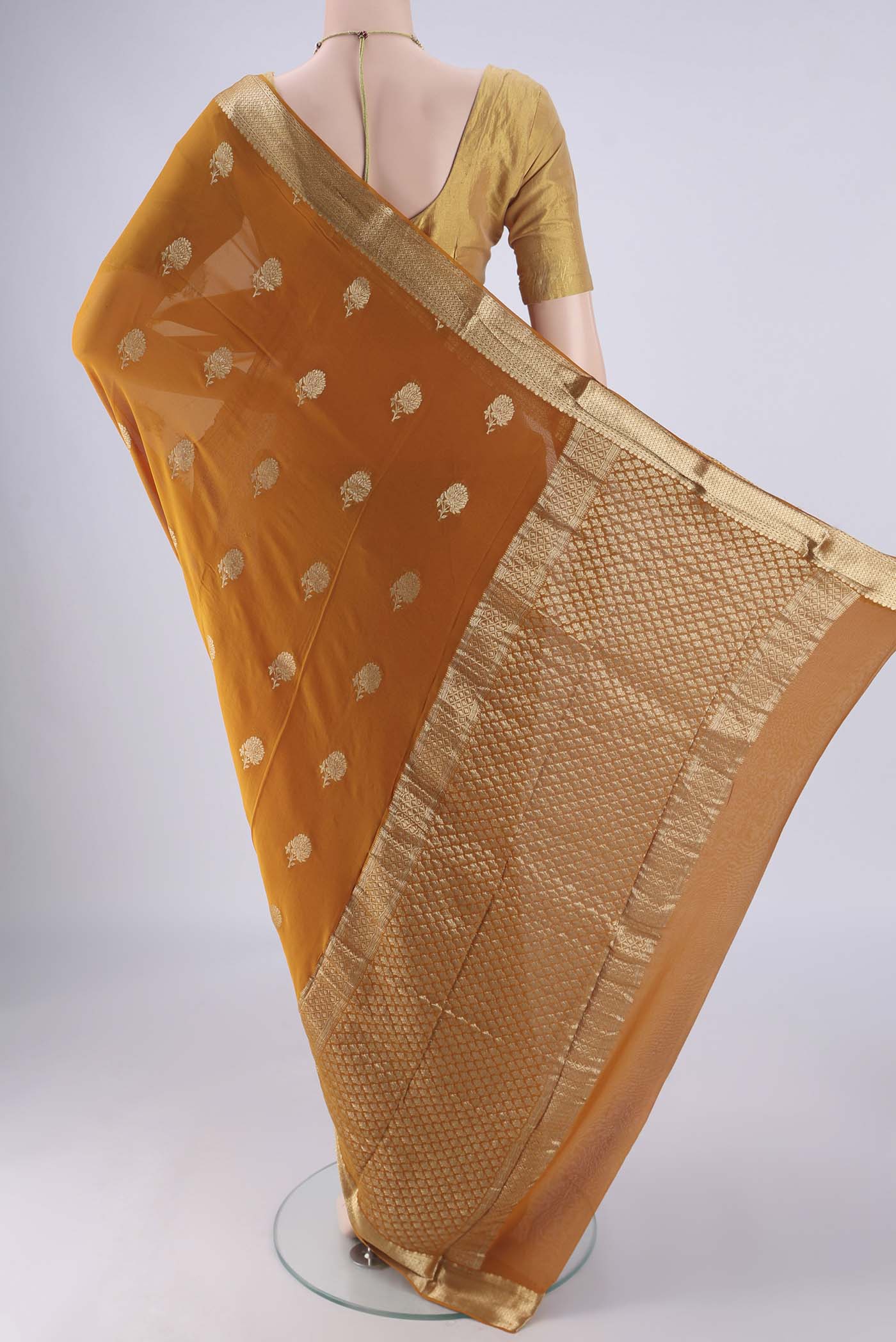 Flat view of Mustard Mysore Georgette Saree with Zari Butta on the body and Zari Border. 