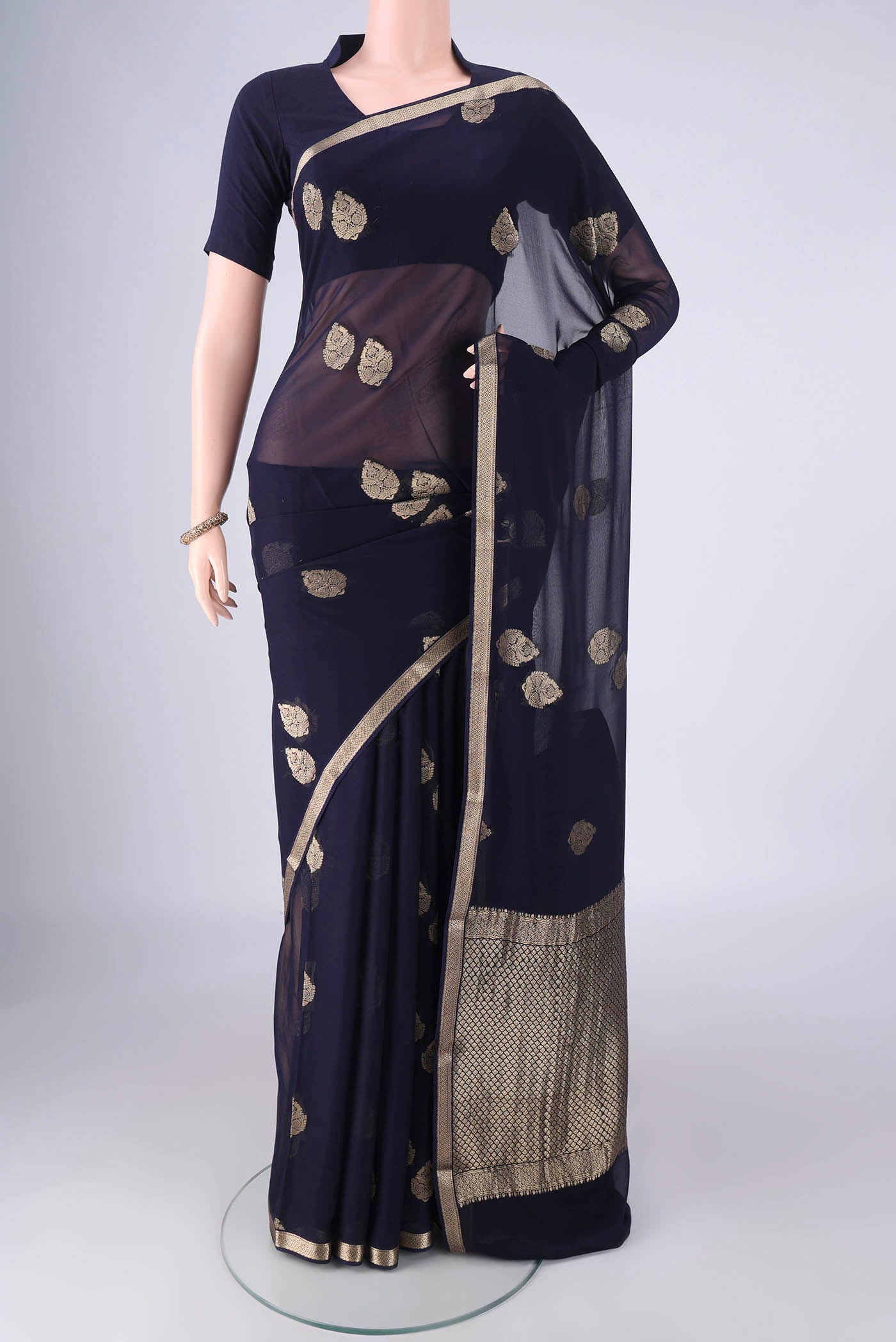 Navy Blue Mysore Georgette Saree with Zari Butta on the body and Zari Border.  displayed on a mannequin