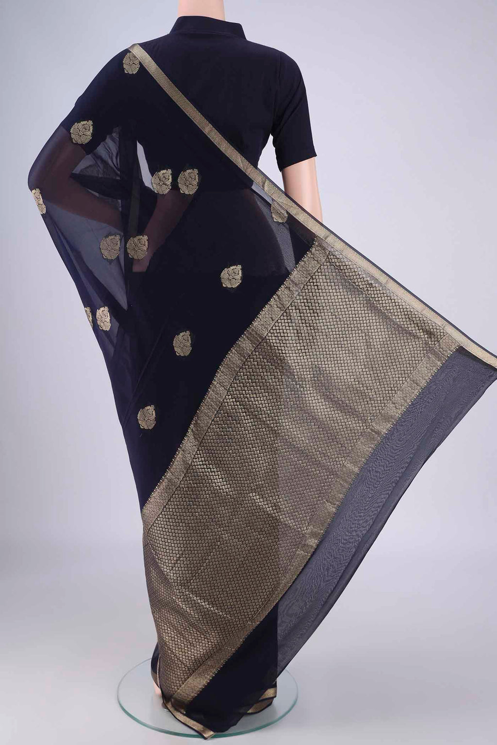Flat view of Navy Blue Mysore Georgette Saree with Zari Butta on the body and Zari Border. 