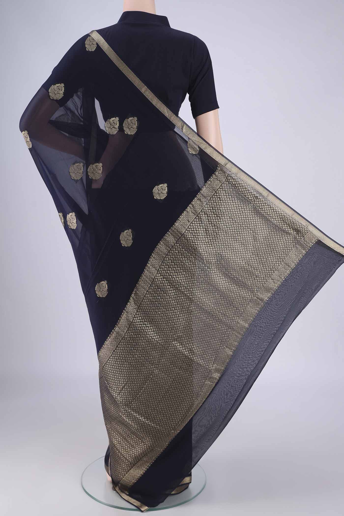 Flat view of Navy Blue Mysore Georgette Saree with Zari Butta on the body and Zari Border. 
