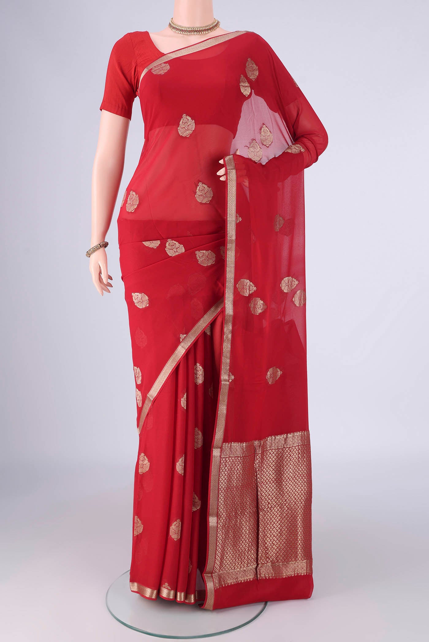 Red Mysore Georgette Saree with Zari Butta on the body and Zari Border.  displayed on a mannequin