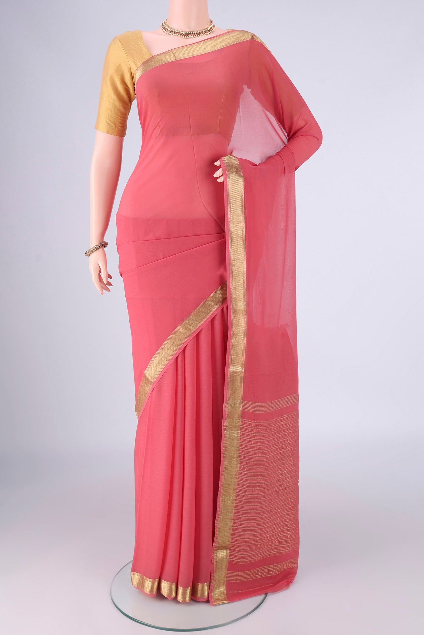 Pink Mysore Georgette Saree with Plain Body and Zari Border.  displayed on a mannequin