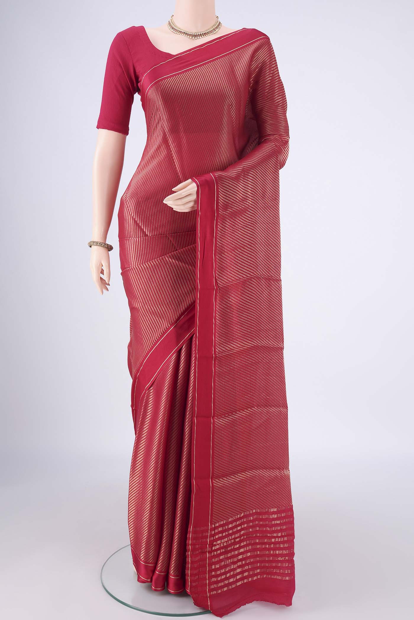 Rani Pink Mysore Crepe Saree with Zari Brocade on the body and Zari Border.  displayed on a mannequin