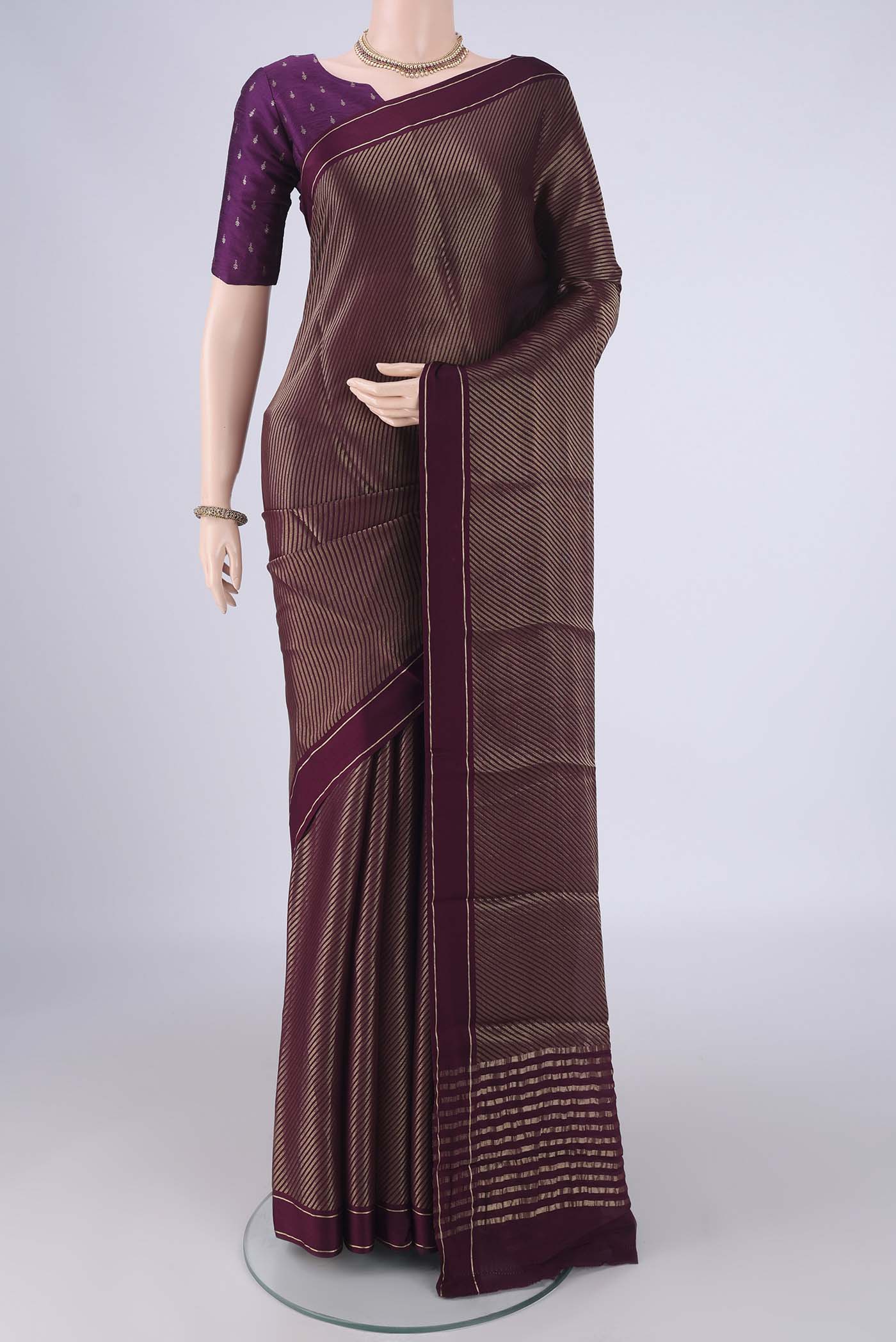 Burgundy Mysore Crepe Saree with Zari Butta on the body and Thin Zari Line.  displayed on a mannequin