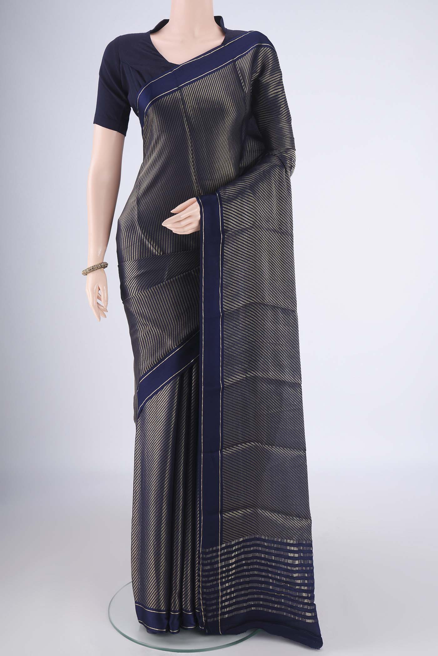 Navy Blue Mysore Crepe Saree with Zari Brocade on the body and Zari Border.  displayed on a mannequin