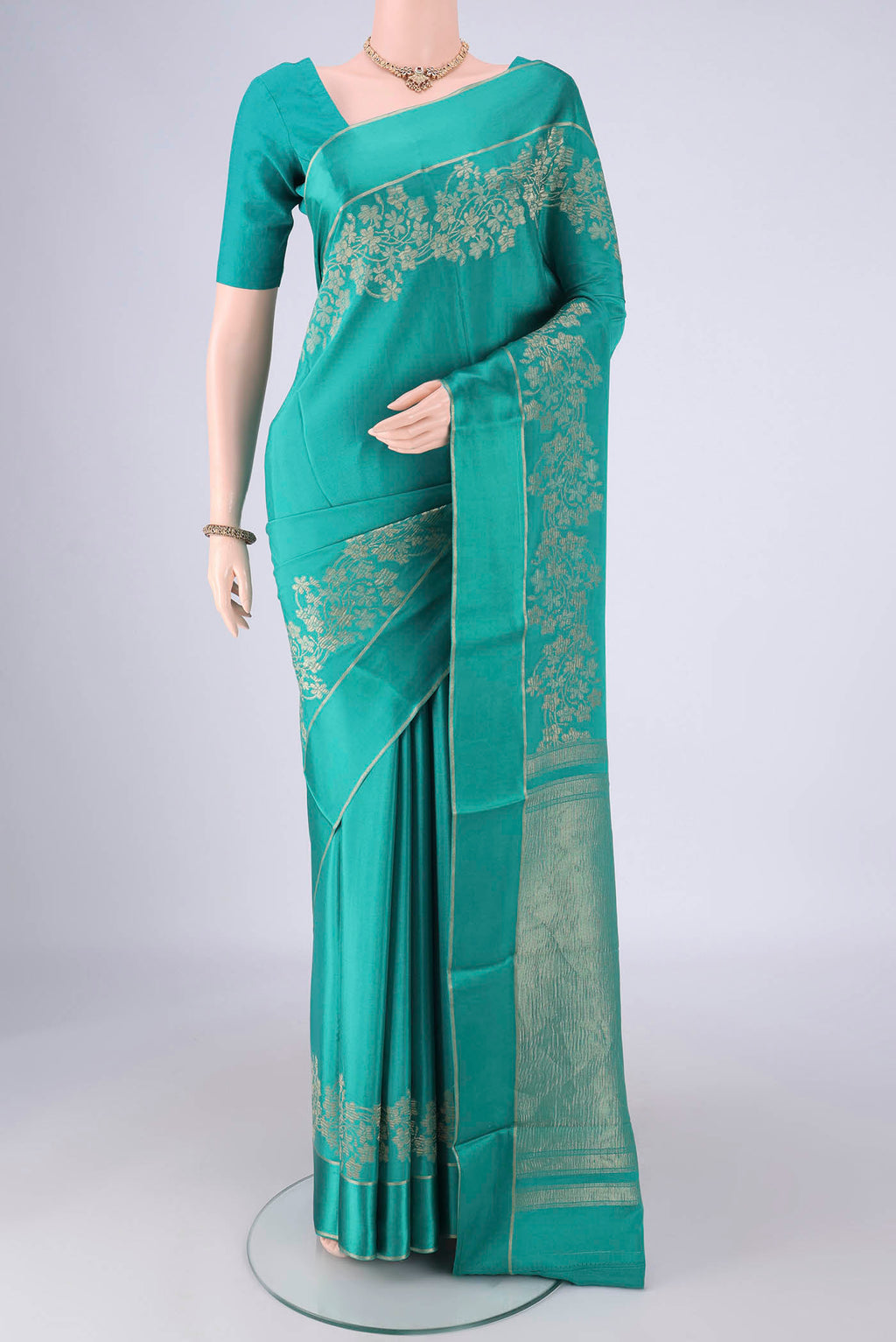 Sea Green Mysore Crepe Saree with Zari Butta on the body and Thin Zari Line.  displayed on a mannequin