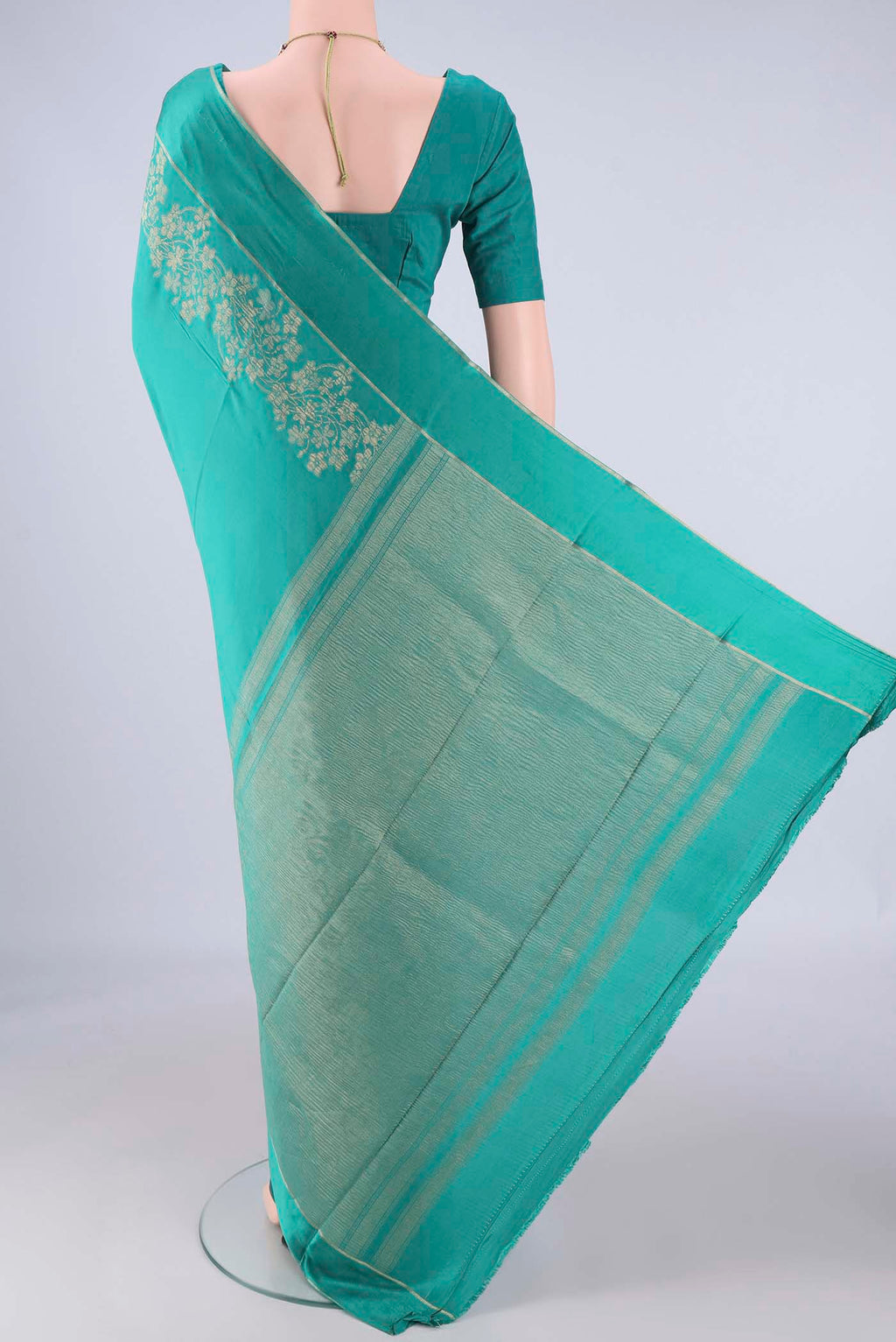 Flat view of Sea Green Mysore Crepe Saree with Zari Butta on the body and Thin Zari Line. 