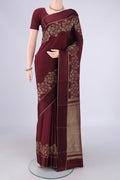 Maroon Mysore Crepe Saree with Plain Body and Zari Border.  displayed on a mannequin