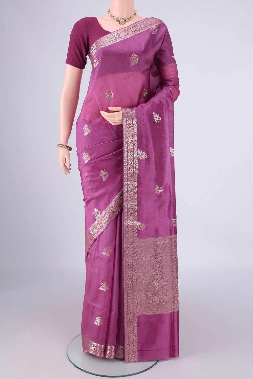 Purple Banarasi Raw Silk Saree with Zari And Thread Butta on the body and Zari And Thread Border.  displayed on a mannequin