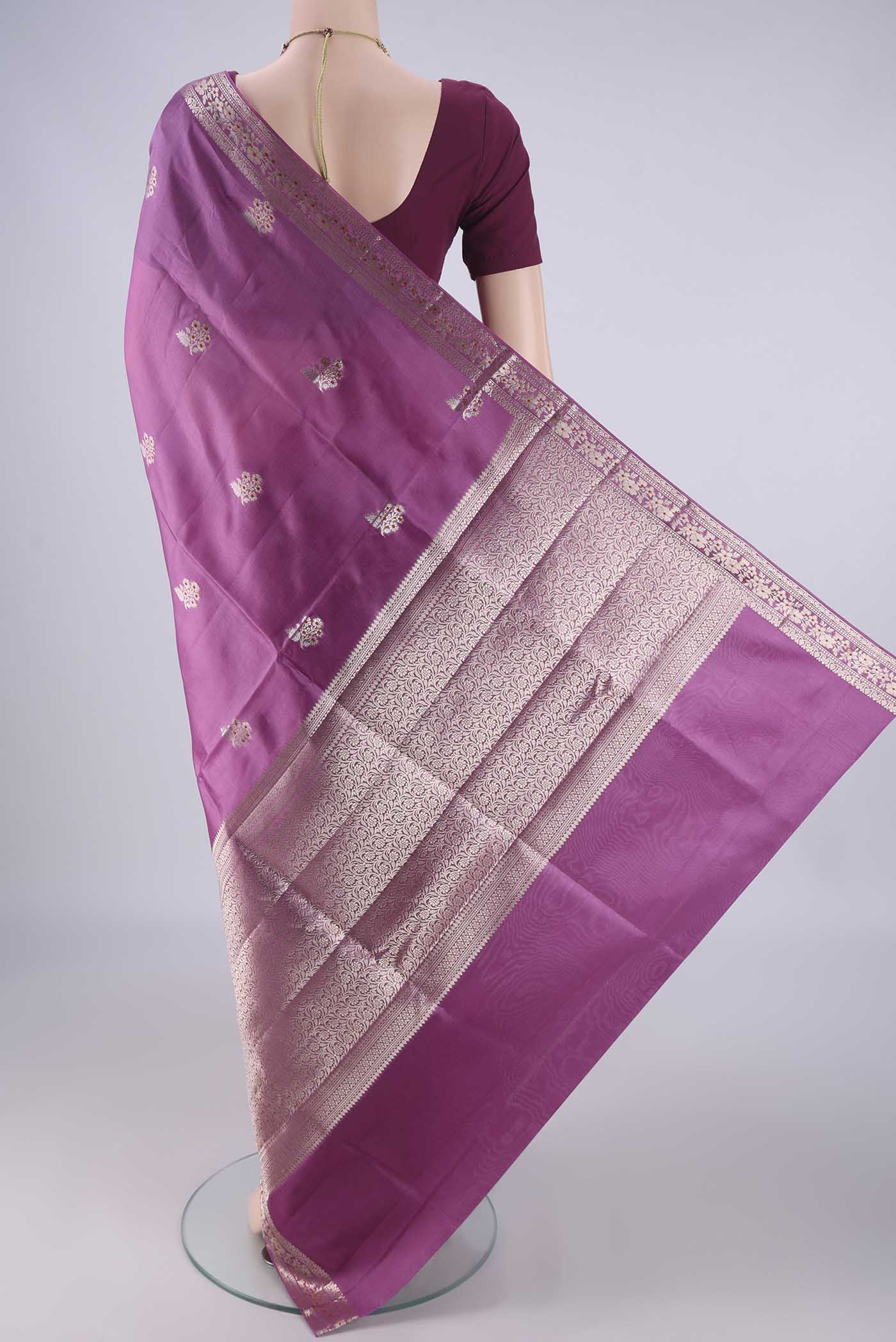 Flat view of Purple Banarasi Raw Silk Saree with Zari And Thread Butta on the body and Zari And Thread Border. 