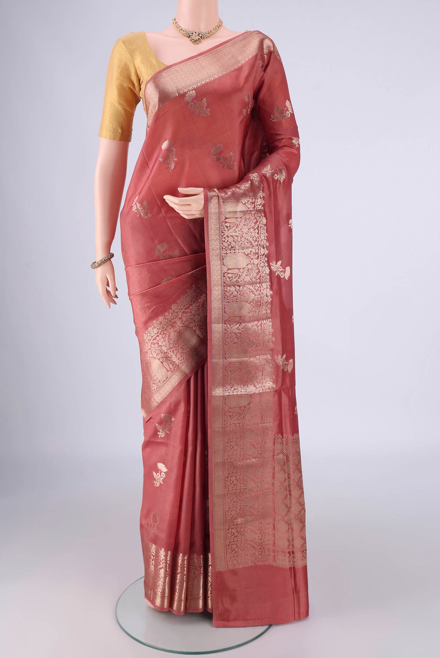Rose Gold Banarasi Raw Silk Saree with Zari And Thread Butta on the body and Zari And Thread Border.  displayed on a mannequin
