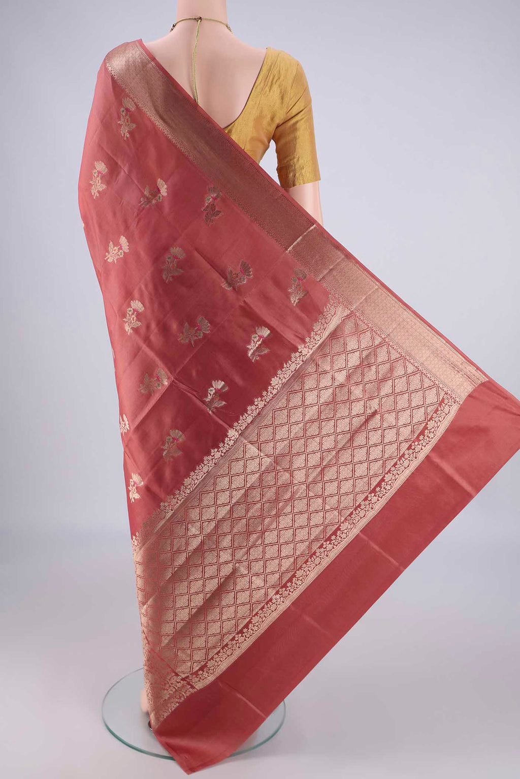 Flat view of Rose Gold Banarasi Raw Silk Saree with Zari And Thread Butta on the body and Zari And Thread Border. 
