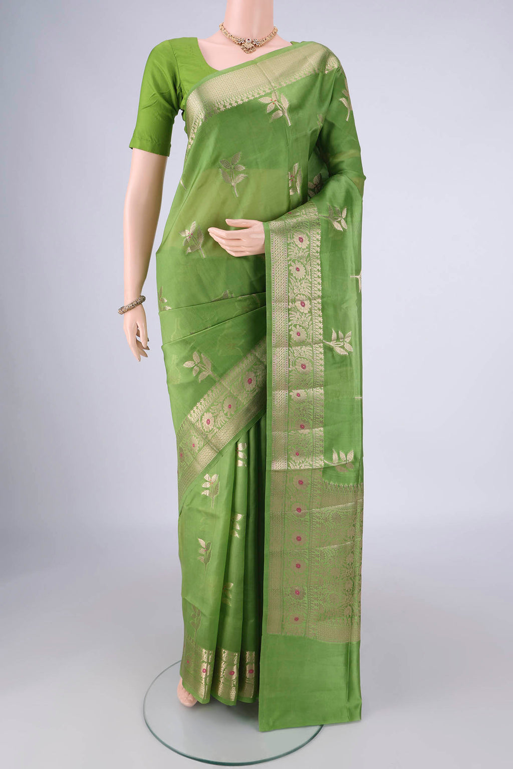 Green Banarasi Raw Silk Saree with Zari And Thread Butta on the body and Zari And Thread Border.  displayed on a mannequin