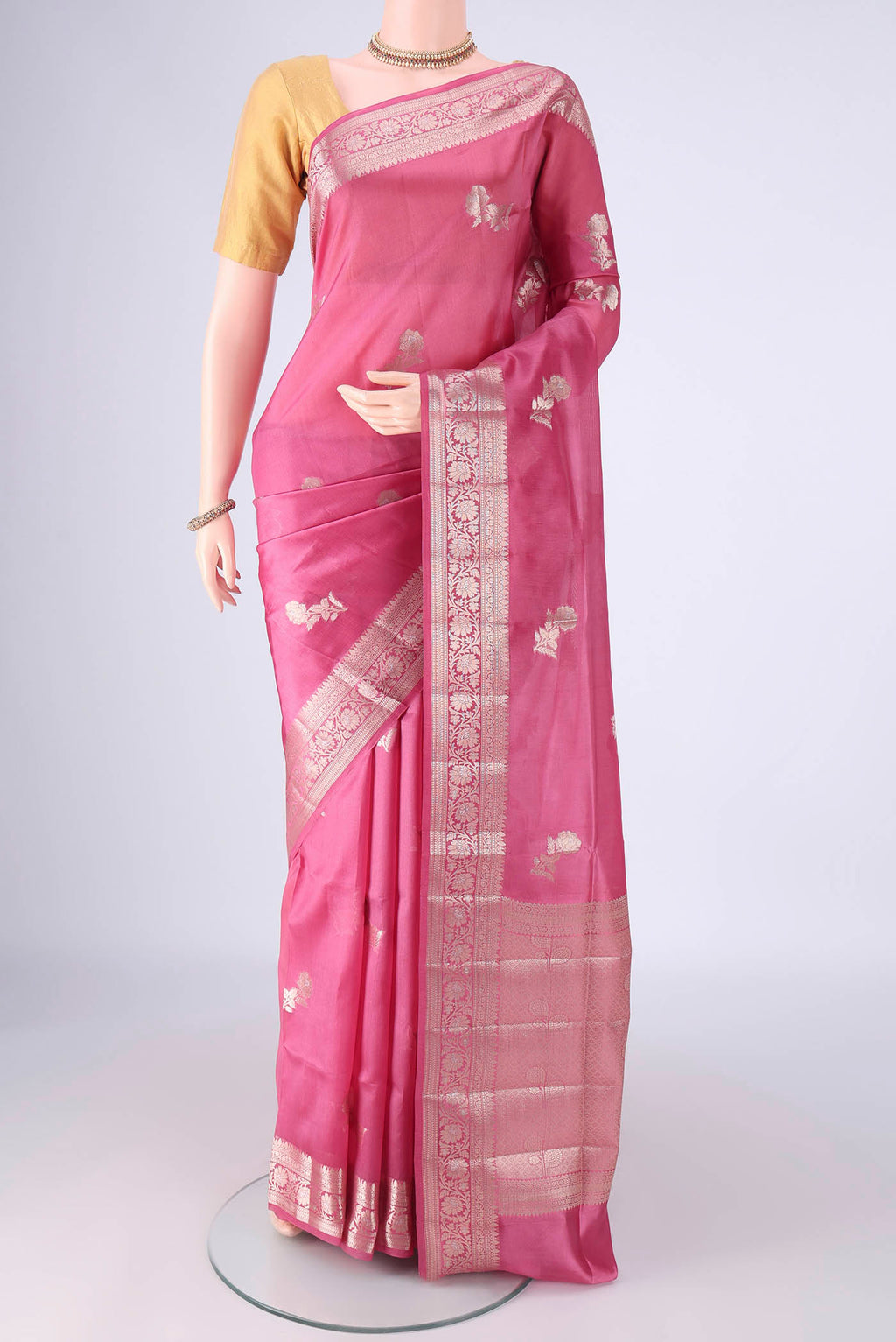 Rose pink Banarasi Raw Silk Saree with Zari Butta on the body and Zari Border.  displayed on a mannequin