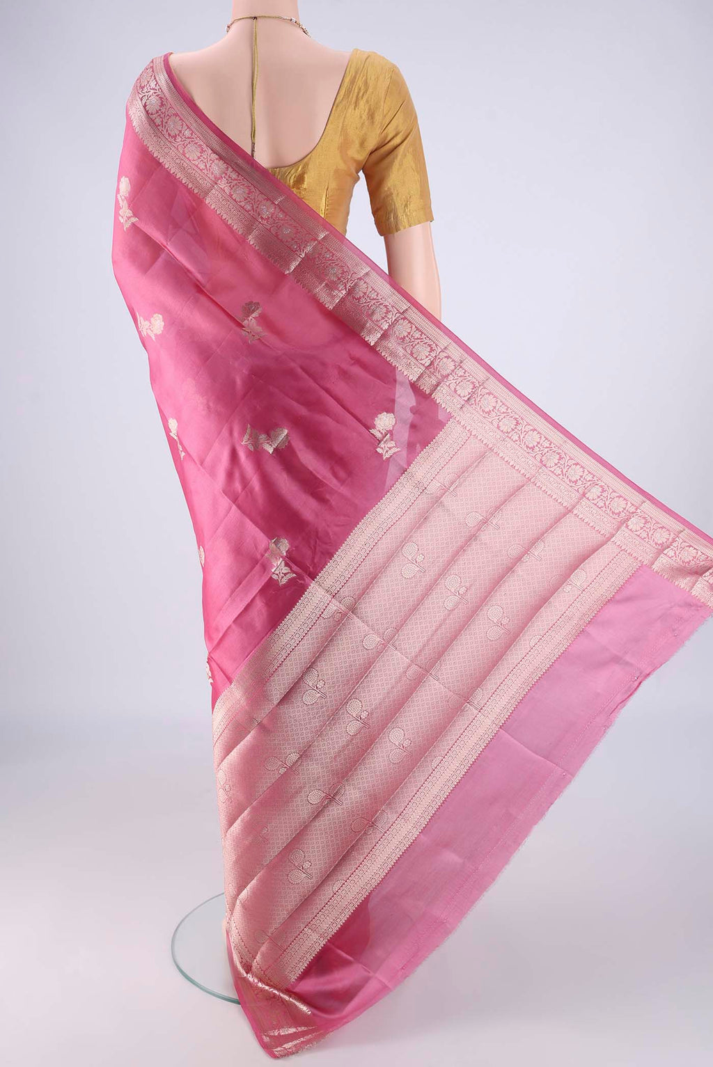 Flat view of Rose pink Banarasi Raw Silk Saree with Zari Butta on the body and Zari Border. 