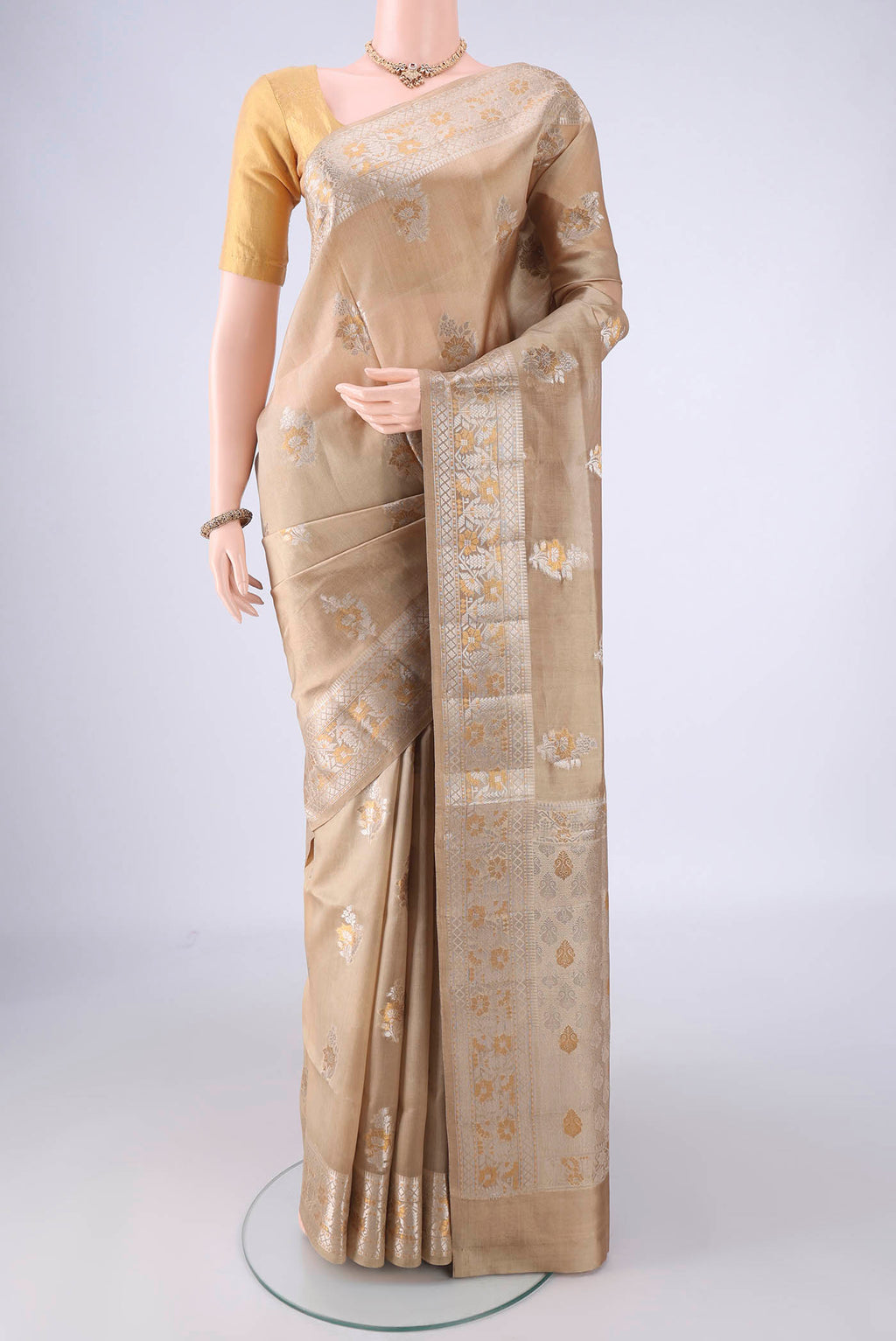 Dark Beige Banarasi Raw Silk Saree with Zari Butta on the body and Zari Border.  displayed on a mannequin