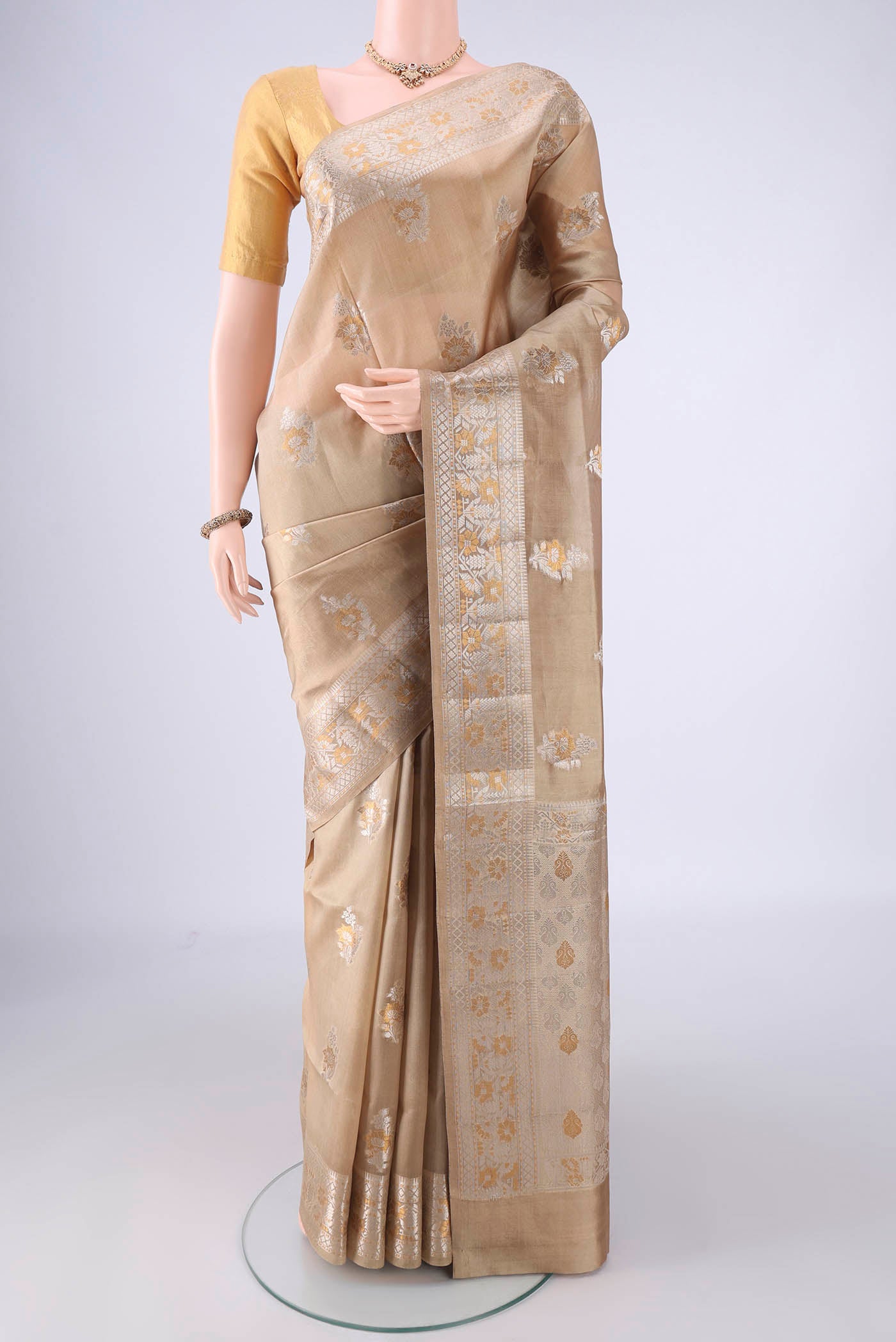 Dark Beige Banarasi Raw Silk Saree with Zari Butta on the body and Zari Border.  displayed on a mannequin