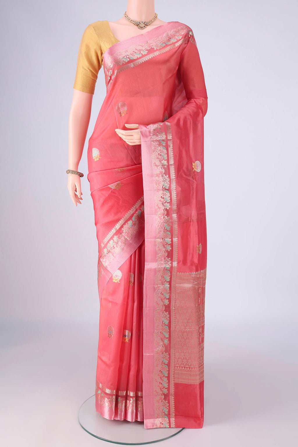 Coral Banarasi Raw Silk Saree with Zari And Thread Butta on the body and Zari And Thread Border.  displayed on a mannequin