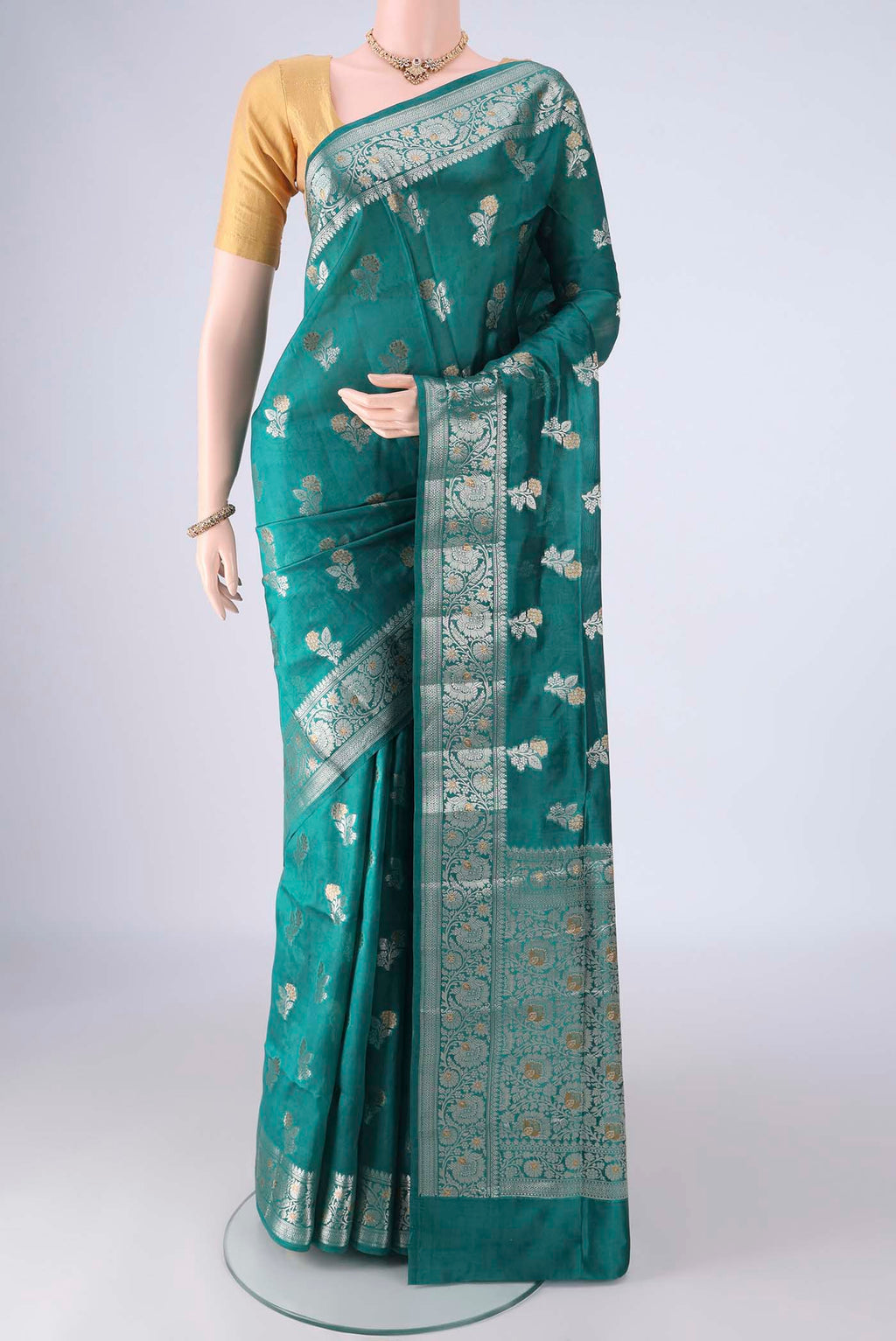 Sea Green Banarasi Raw Silk Saree with Zari Butta on the body and Zari Border.  displayed on a mannequin