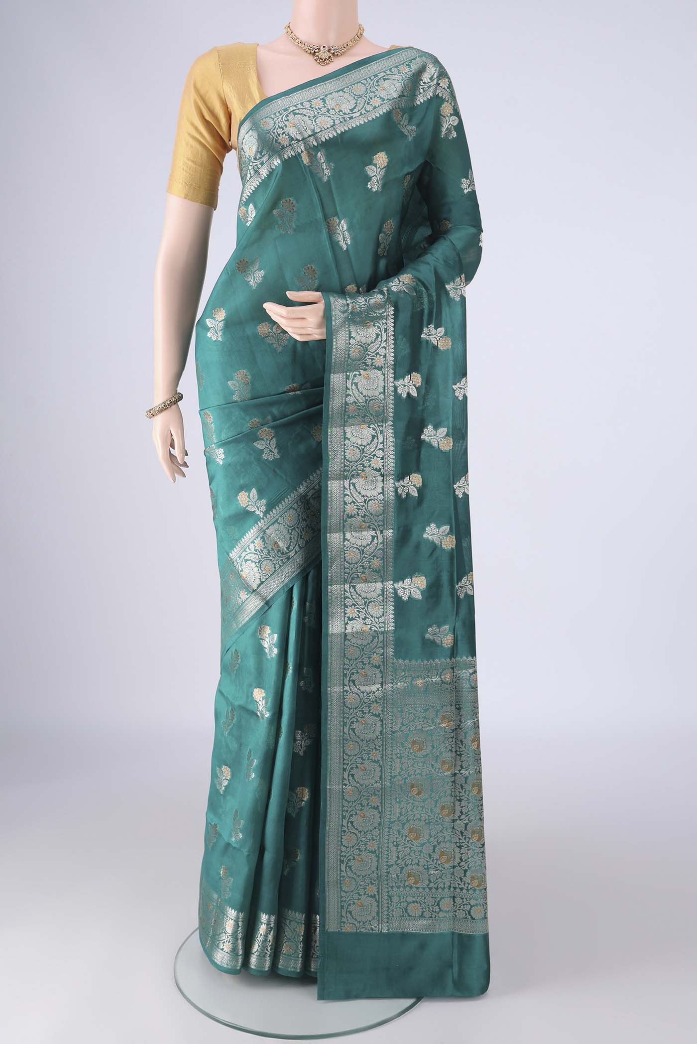 Sea Green Banarasi Raw Silk Saree with Zari Butta on the body and Zari Border.  displayed on a mannequin