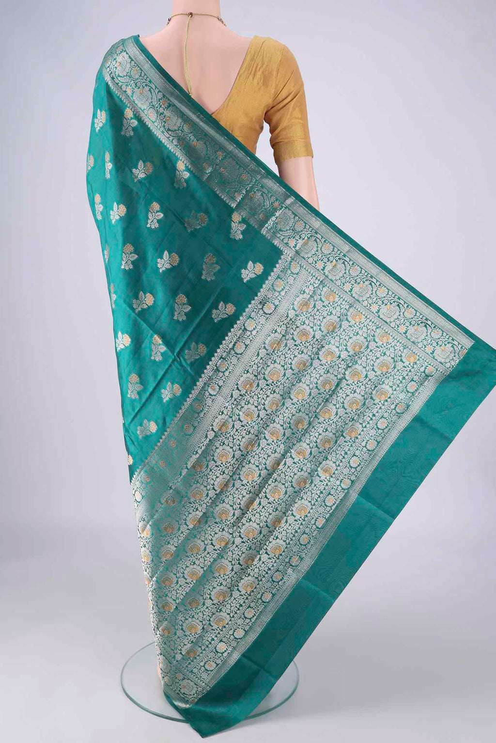 Flat view of Sea Green Banarasi Raw Silk Saree with Zari Butta on the body and Zari Border. 