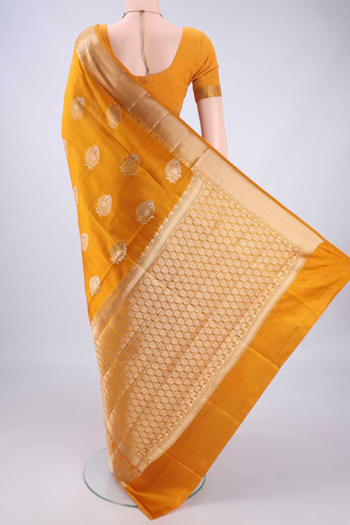 Flat view of Mustard Banarasi Raw Silk Saree with Zari Butta on the body and Zari Border. 