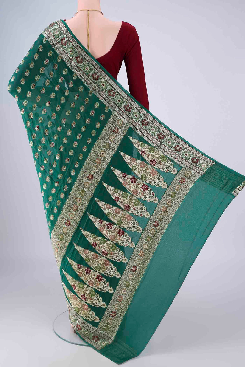 Flat view of Green Blended Banarasi Georgette Saree with Zari And Thread Butta on the body and Zari And Thread Border. 