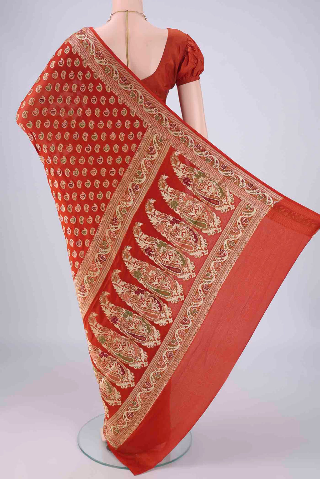 Flat view of Brick Orange Blended Banarasi Georgette Saree with Thread Butta on the body and Zari And Thread Border. 