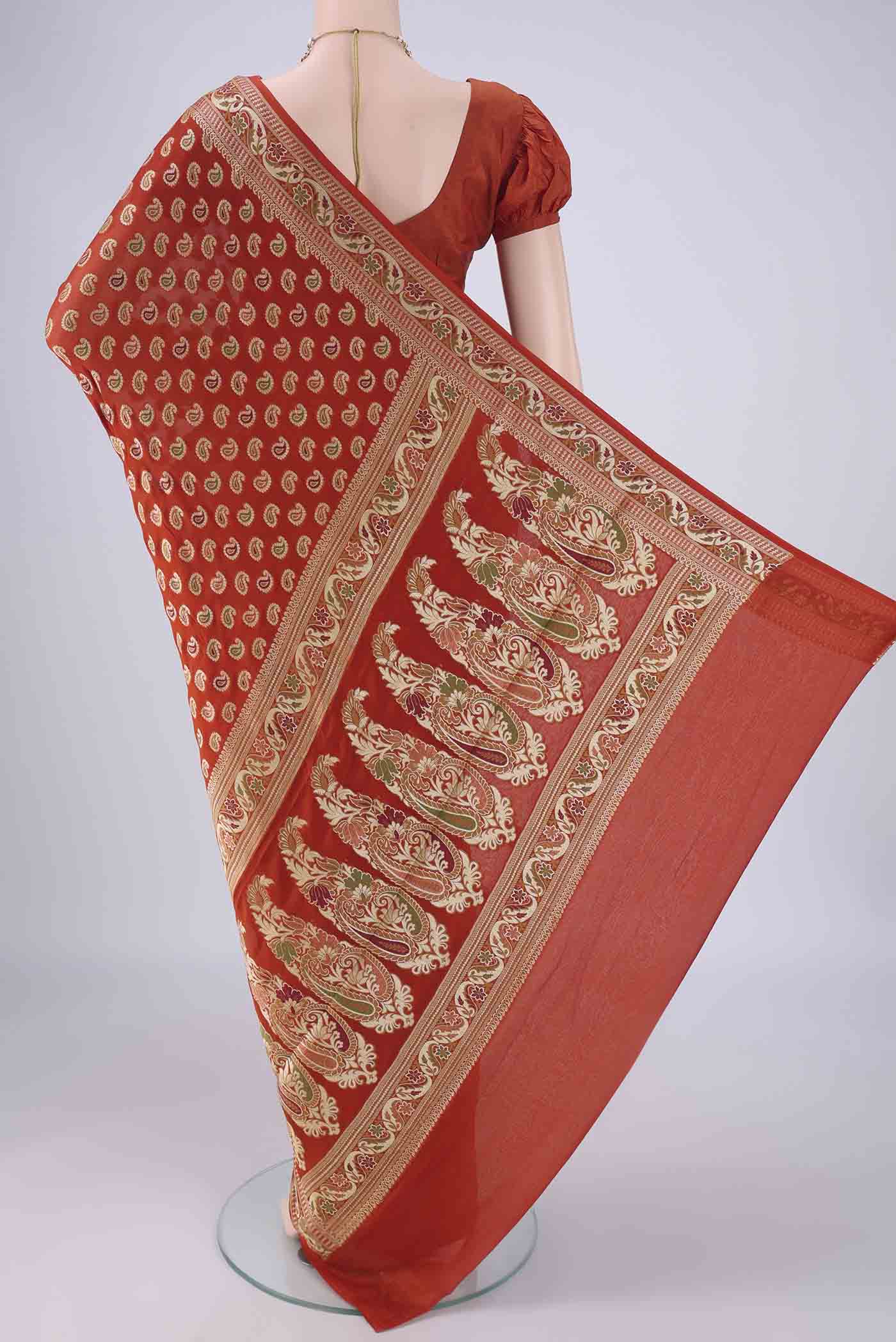 Flat view of Brick Orange Blended Banarasi Georgette Saree with Thread Butta on the body and Zari And Thread Border. 