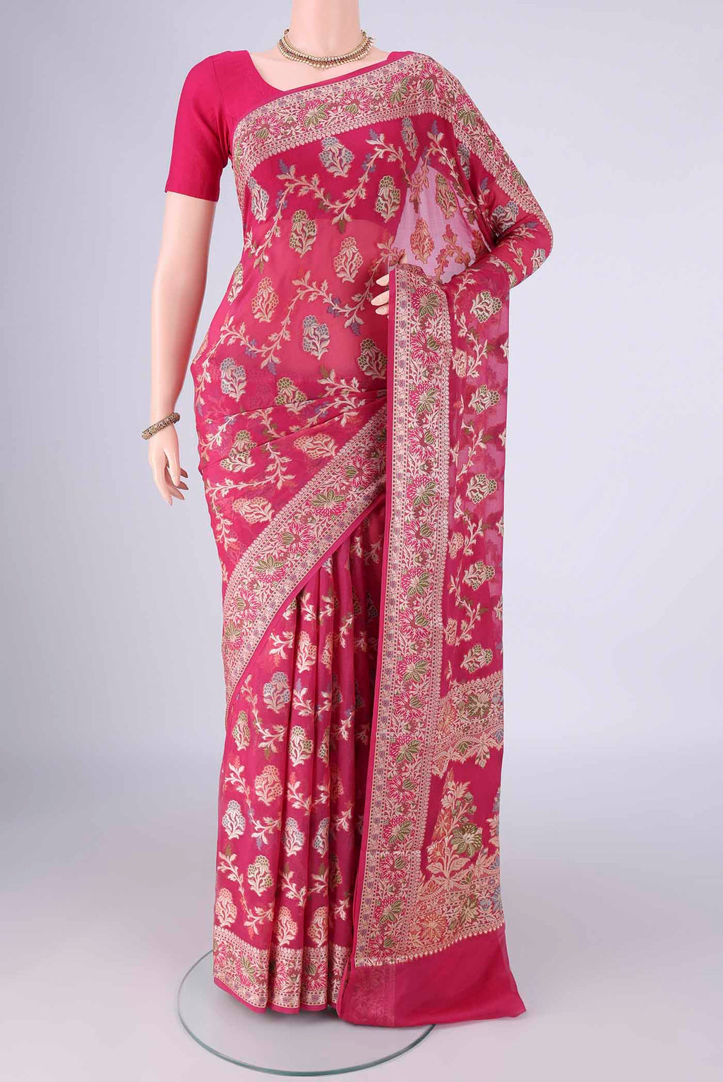 Rani Pink Blended Banarasi Georgette Saree with Zari And Thread Butta on the body and Zari And Thread Border.  displayed on a mannequin