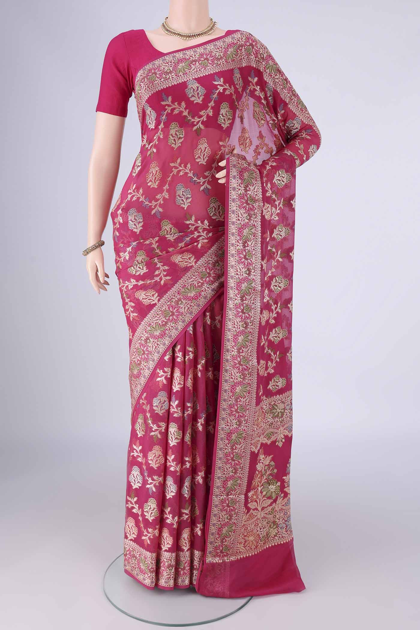 Rani Pink Blended Banarasi Georgette Saree with Zari And Thread Butta on the body and Zari And Thread Border.  displayed on a mannequin